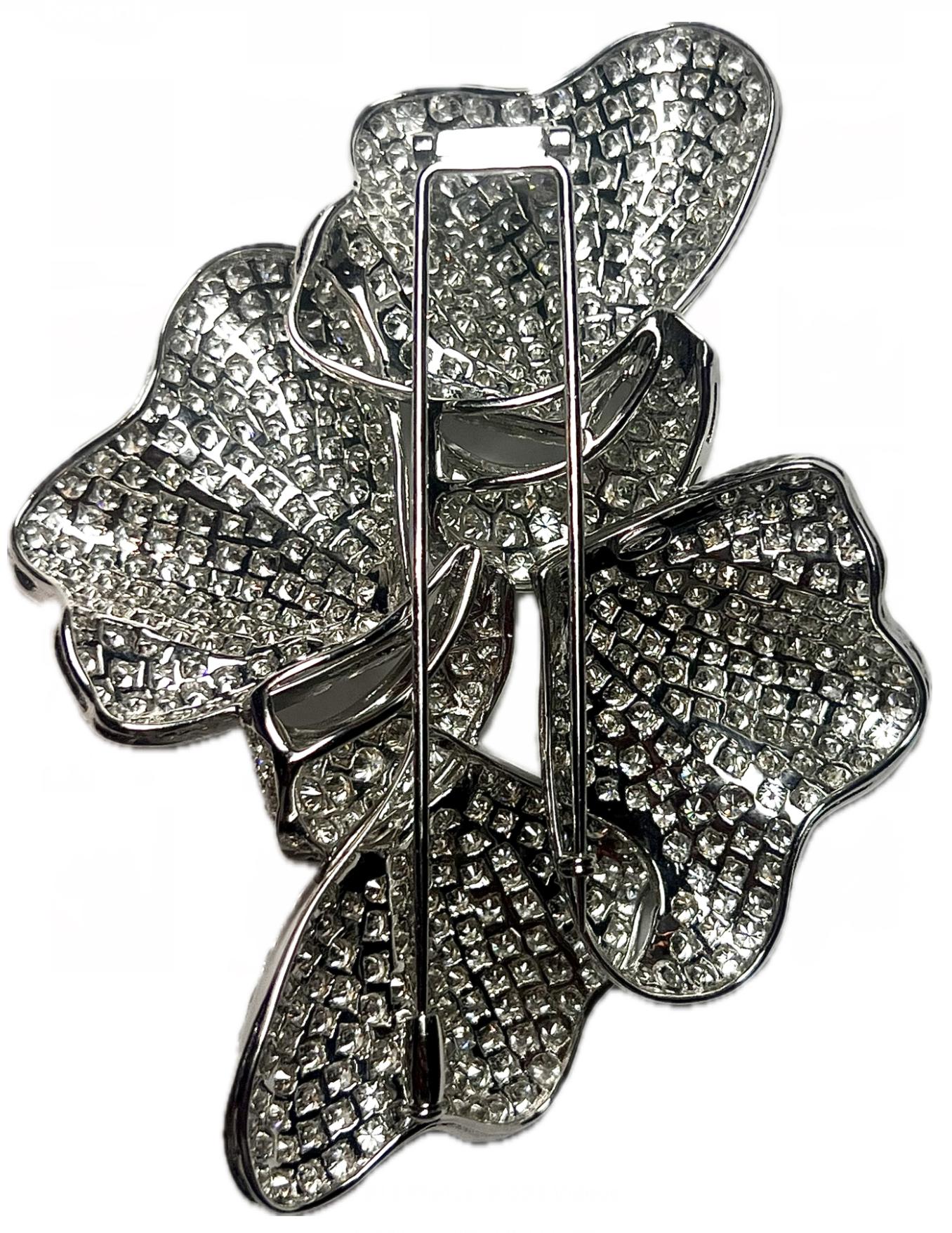 ntroducing the stunning Large 18K White Gold Double Bow Brooch, adorned with an impressive 27 carats of the finest quality VVS white natural diamonds. Custom-made to perfection, this brooch commands attention with its luxurious design, making it red