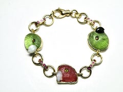 18k bracelet w pink tourmaline/peridot parrot heads