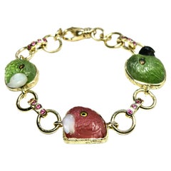 Bracciale in 18 carati con tormalina rosa/peridoto a testa di pappagallo