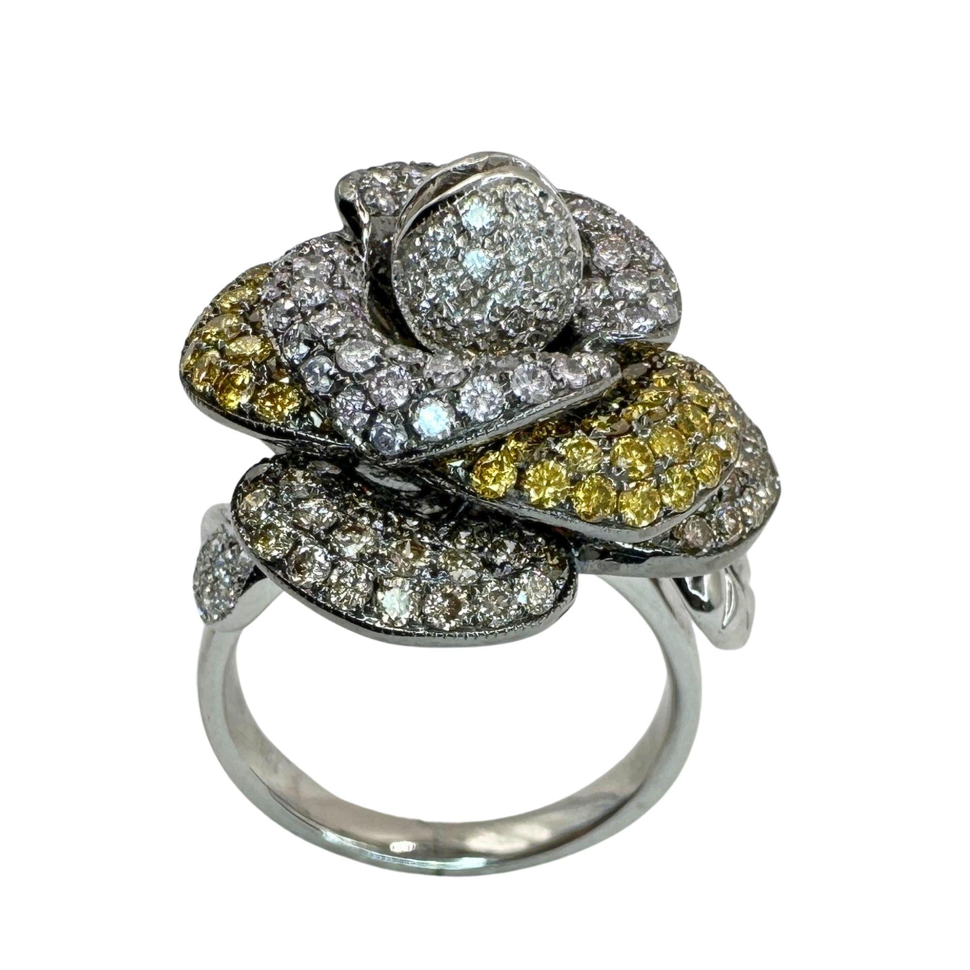 Expertly crafted from 18k white gold, this stunning flower ring features a combination of irradiated yellow, natural brown, and natural white diamonds. With a total weight of 2.71 carats, this ring is sure to make a statement. In excellent condition
