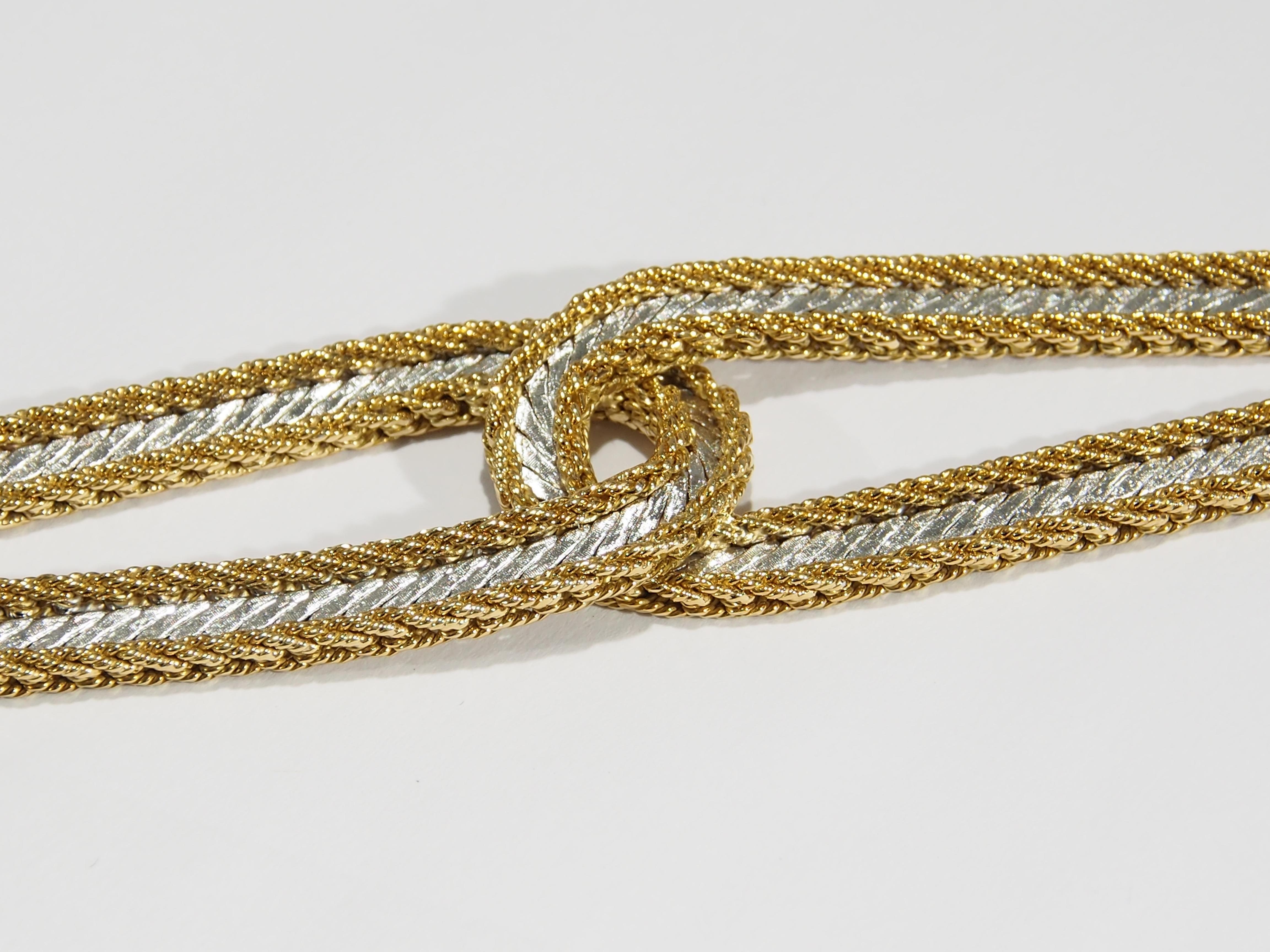 From the well respected jewelry designer, Buccellati, is this 18K Yellow Gold Bracelet. A timeless style with Yellow Gold roping accenting a Flatten White Gold braid fashioned in an interlocking link. The widest portion is 1 inch in width tapering