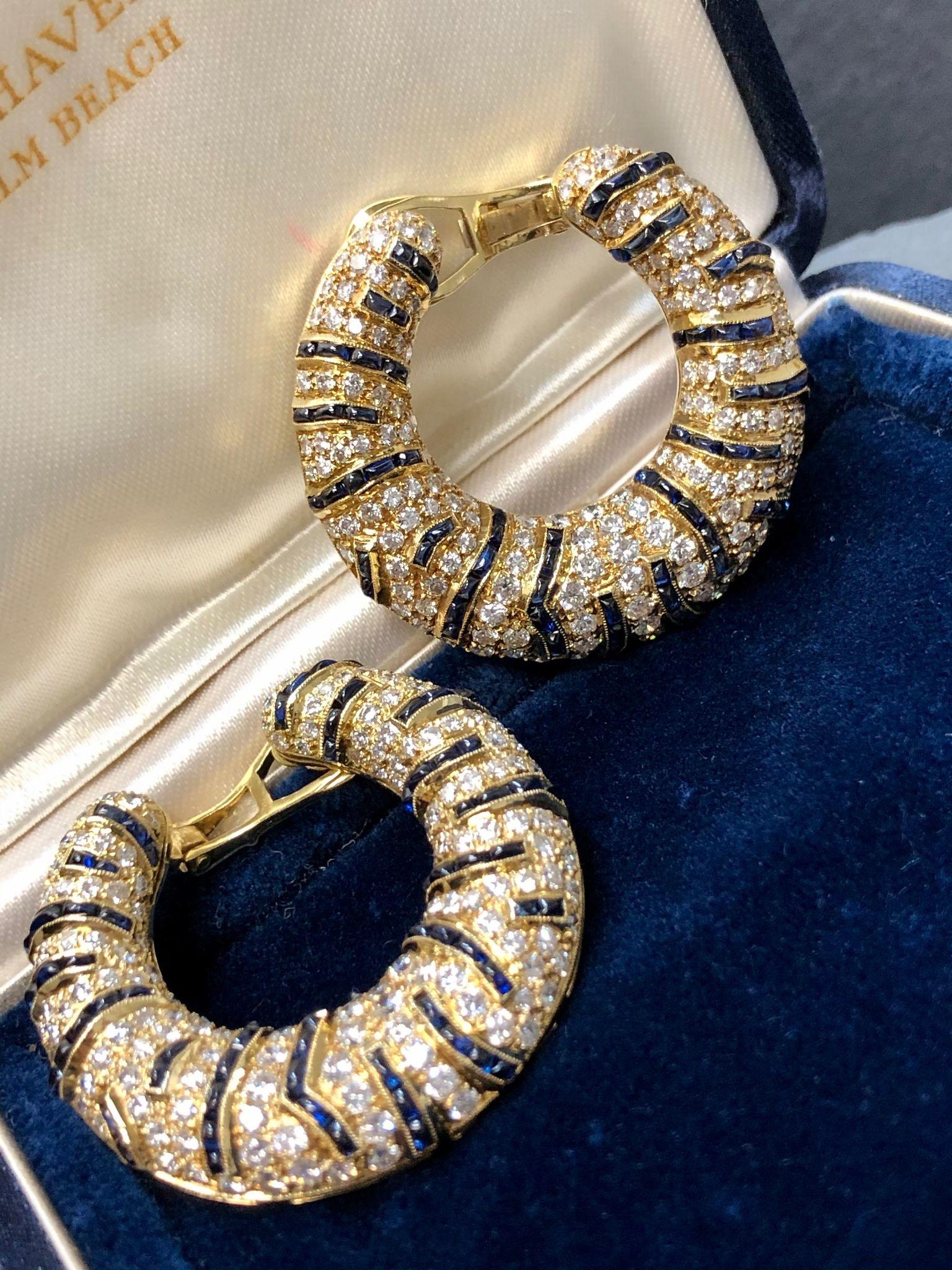 A fabulous pair of lever-back hoop earrings done in 18K yellow gold set with approximately 6.40cttw in F-G color Vs1-2 clarity diamonds as well as approximately 5.45cttw in natural, buff-top sapphires.

Dimensions
Earrings measure 1.4” in