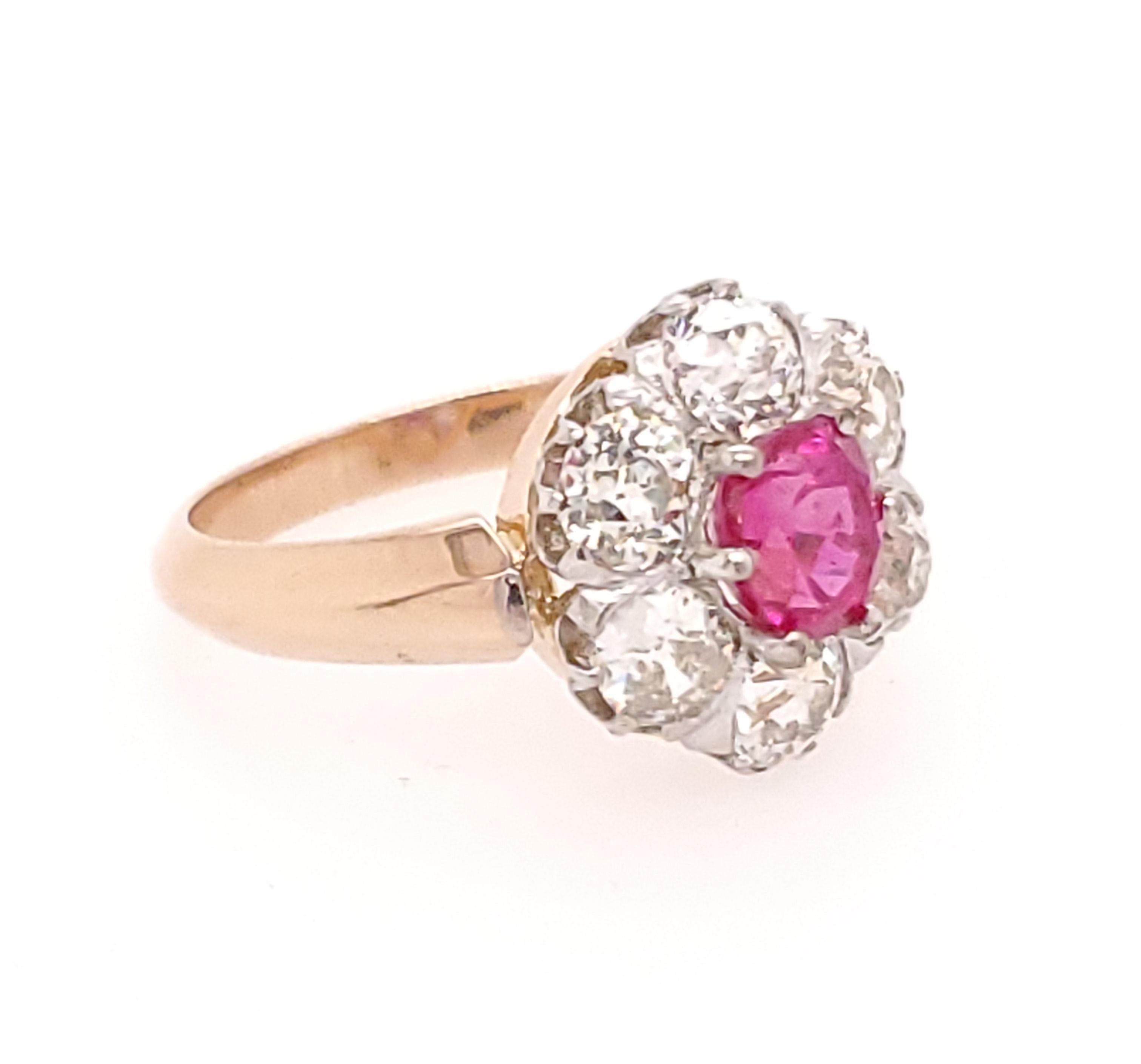 This is an heirloom quality 18K White and Rose Gold Diamond and Ruby Ring. There is 1.09ct Oval non heated Burma Red Ruby GIA #2201383822 Classically styled with (6) Old Mine Diamonds, H-J in Color, VS in Clarity weighing approximately 1.80ctw