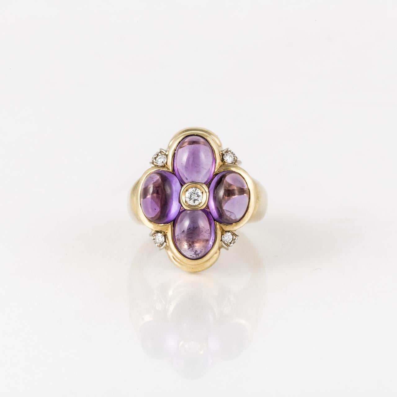 18K yellow gold ring featuring four oval cabochon amethyst stones in a clover-leaf design accented by round diamonds.  The nine round diamonds total 0.35 carats; H-I color and VS clarity.  Measures 7/8 inches long and 11/16 inches wide.  Size 6.25