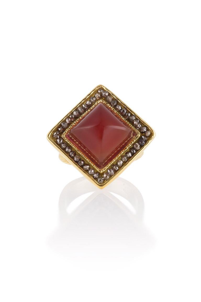 18KY, Loaf cut Carnelian (10.72 CTW) surrounded by Brown Diamonds (3.10 CTW) is a one-of-a-kind show stoping ring, inspired by the carnival of life!  The bright color of the orangish/red sugar loaf cut Carnelian is shown off by the sparkle of the