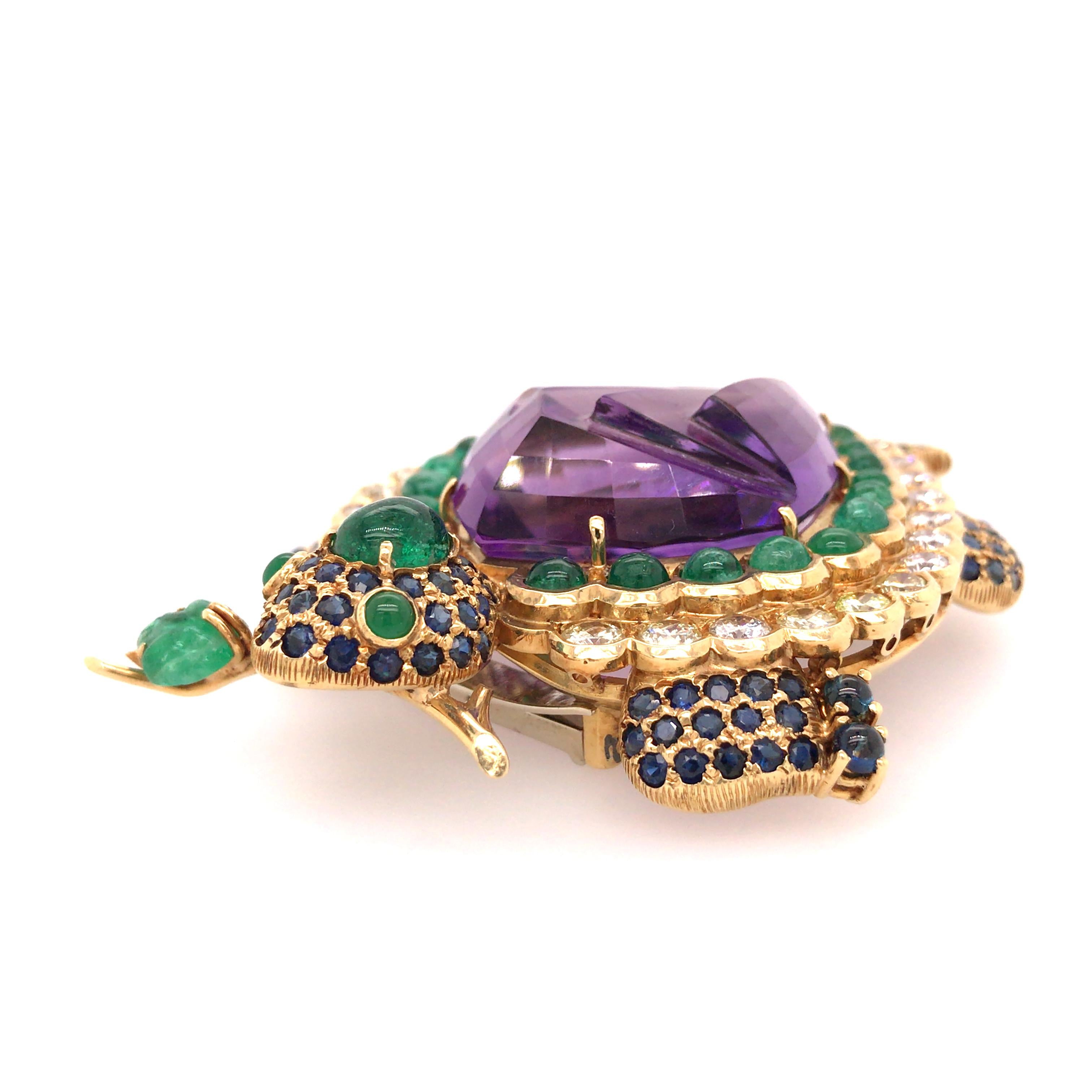 Turtle Pin 15 Carat Amethyst Gemstone Center in 18K Yellow Gold. Round Brilliant Cut Diamonds weighing 3.12 carat total weight, G-H in color and VS in clarity, Sapphires weighing 2.18 carat total weight and Emeralds weighing 6.0 carat total weight