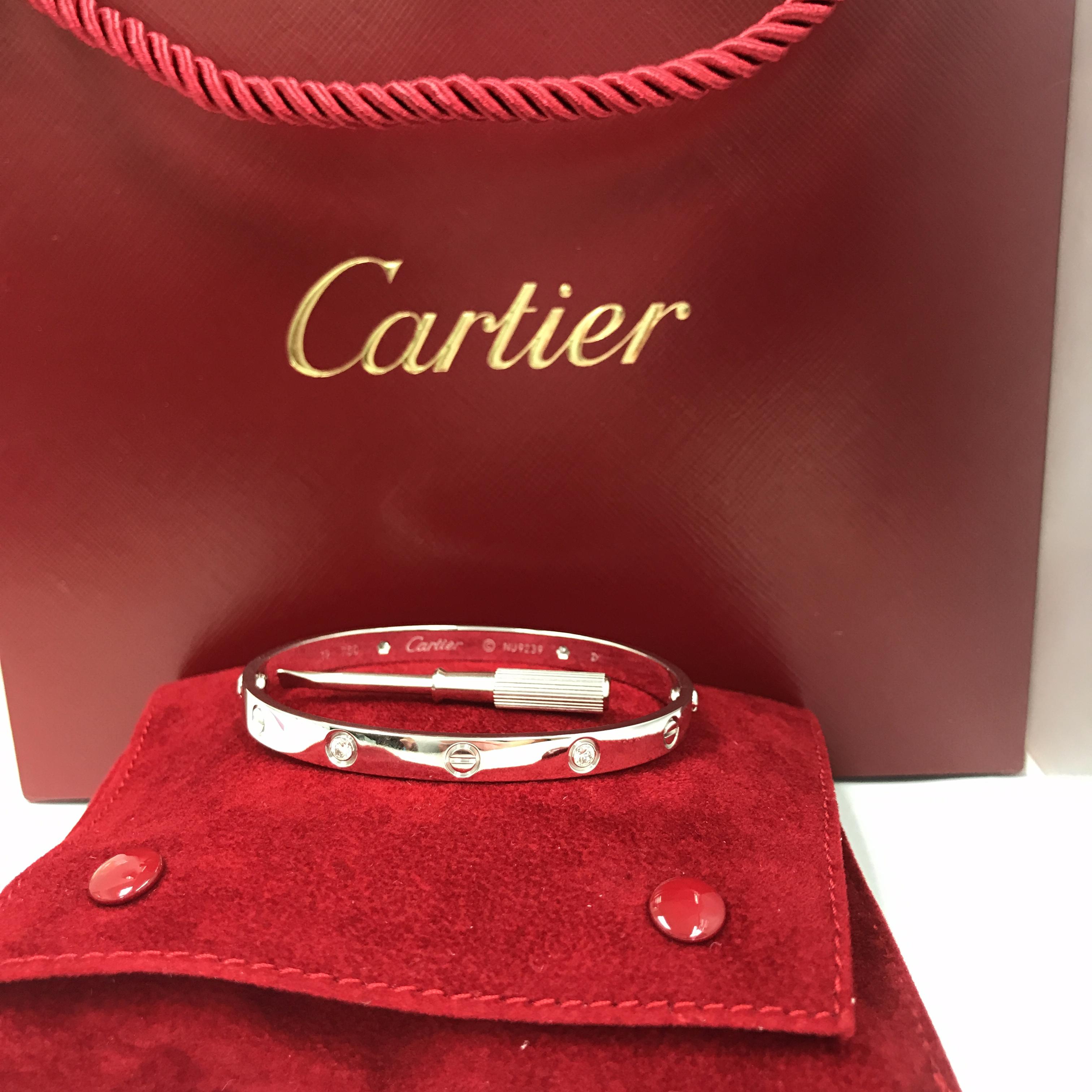 Cartier Love Bracelet in 18K White Gold.  (4) Round Brilliant Cut Diamonds weighing .42 carat total weight, F-G in color, VVS1 are bezel set in this classic Bangle.  Size 19.  35.45 grams.  Cartier Box, Gold Screwdriver and Cartier Certificate