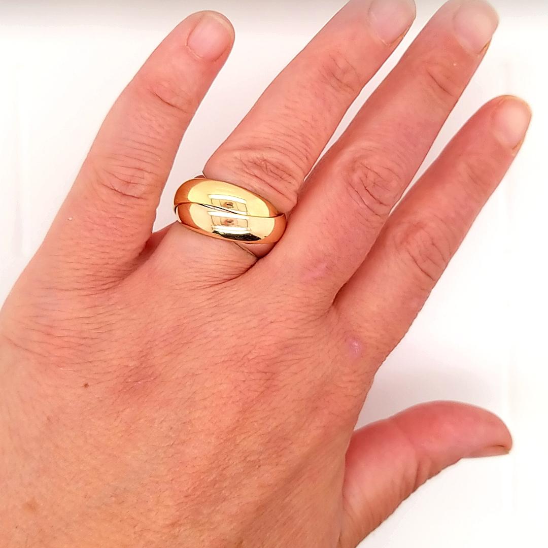 A classic Cartier Trinity ring in 18K White Gold, 18K Rose Gold and 18K Yellow Gold. Each band is 3/16 inch in width.  13.6 grams. Ring size 7 / 54.  Signed.
