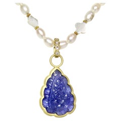18k carved Tanzanite enhancer, with Diamond bail