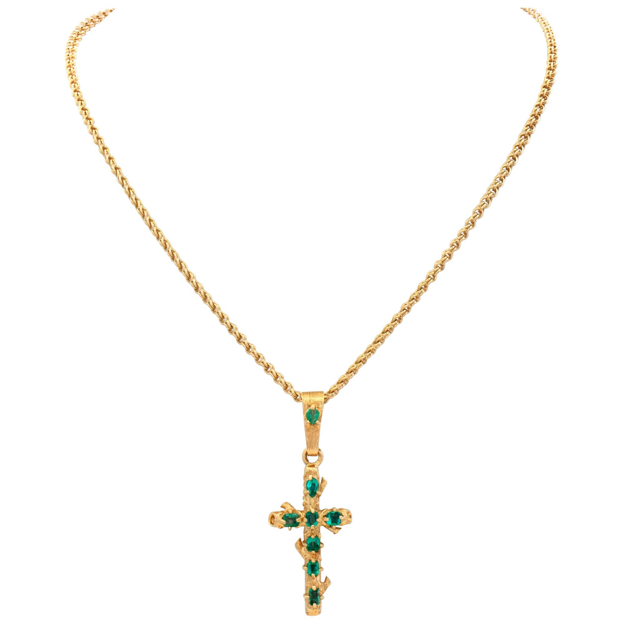 Unique 18k yellow gold chain with 18k yellow gold cross pendant with approximately 2 carats in emeralds. Cross length 1.5