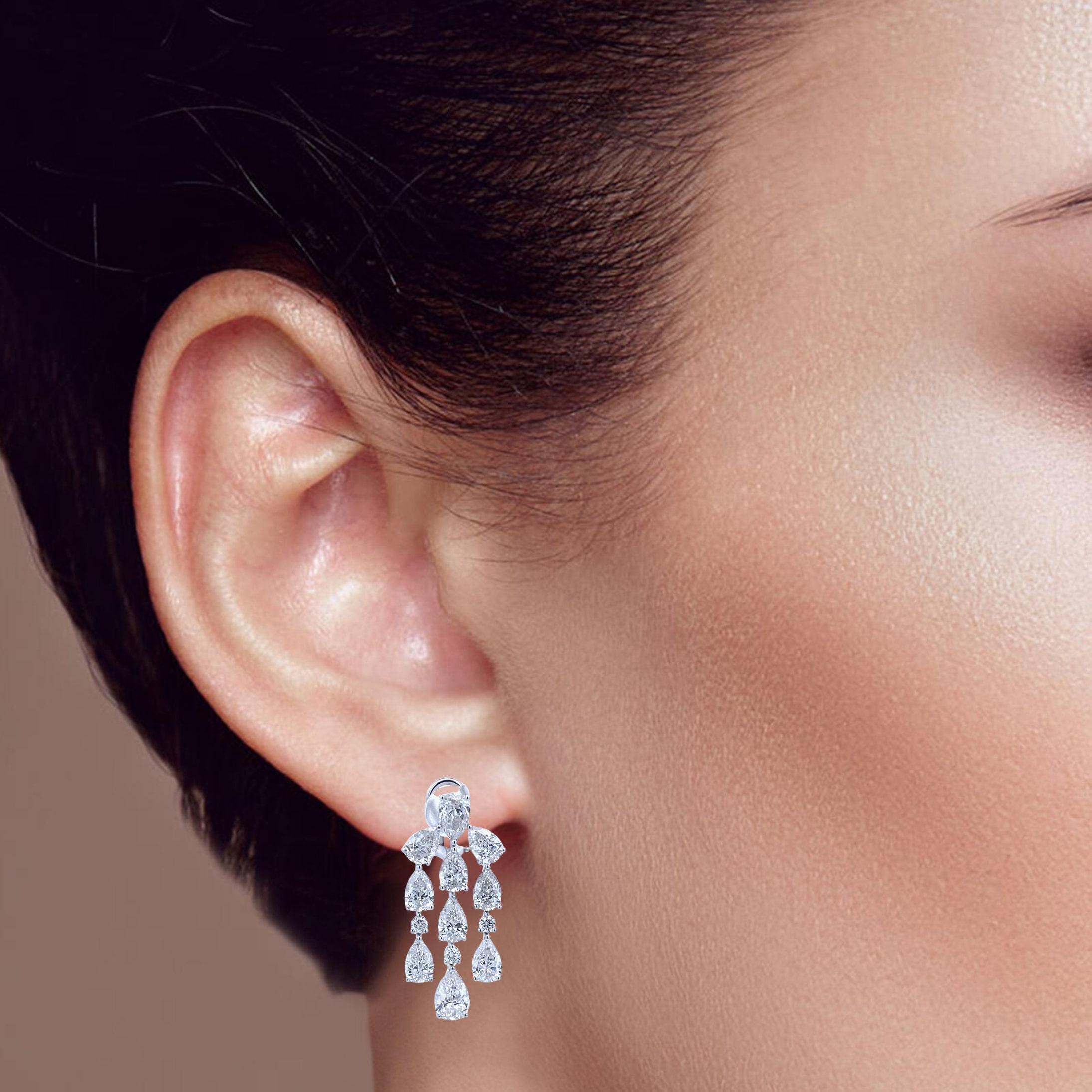 These 14k white gold dangling earrings feature a classic pear-shaped drop design, adorned with natural round-cut diamonds. Elegant and versatile, they add a touch of sparkle to any outfit. Perfect for both everyday wear and special