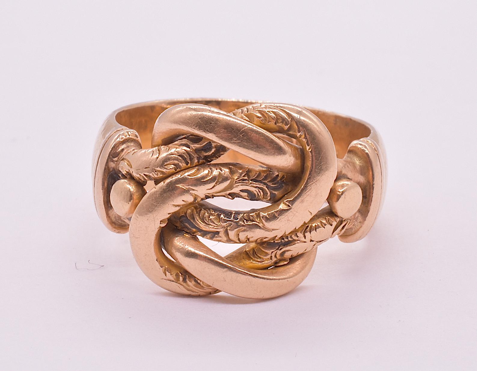 We love everything about this antique, chunky 18K gold lover's knot ring with hallmarks for Chester, 1912, beginning with its solid feel to its hand forged sinuous intertwined bands of gold, some with charming incised flourishes. We also love the