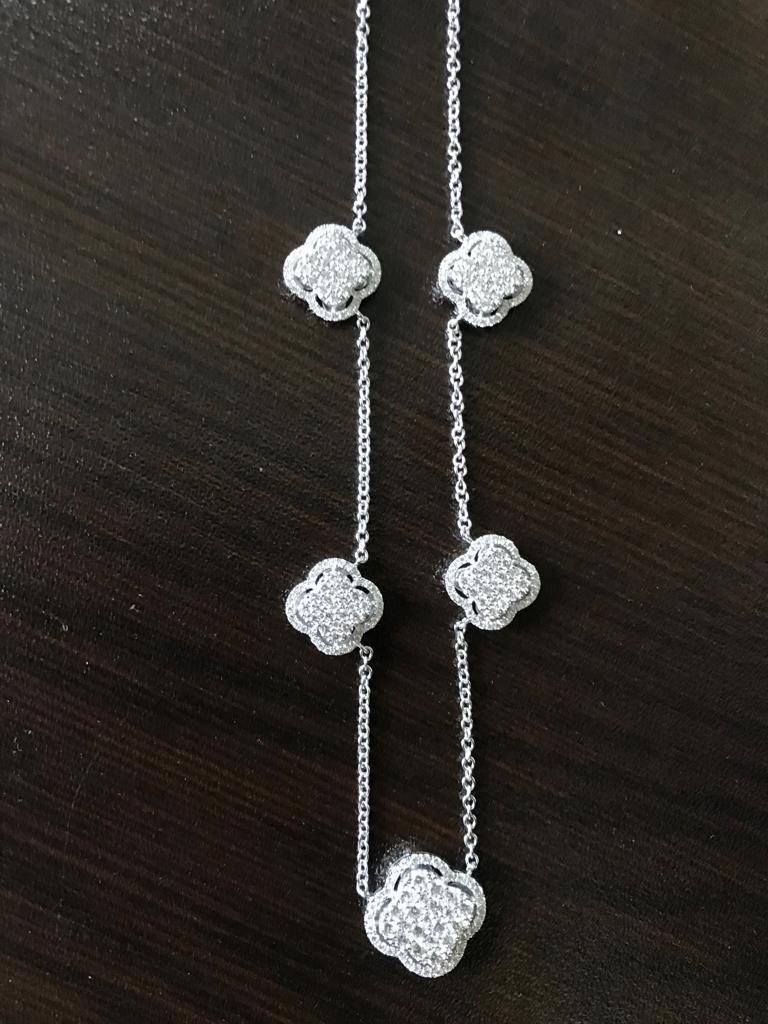 This diamond necklace consists of 5 clover diamond pendants set 1 1/2 inch apart from each other. It's a classic, but yet fashionable piece. The total weight is 1.71 carats. The color of the stones is G, the clarity is VS.