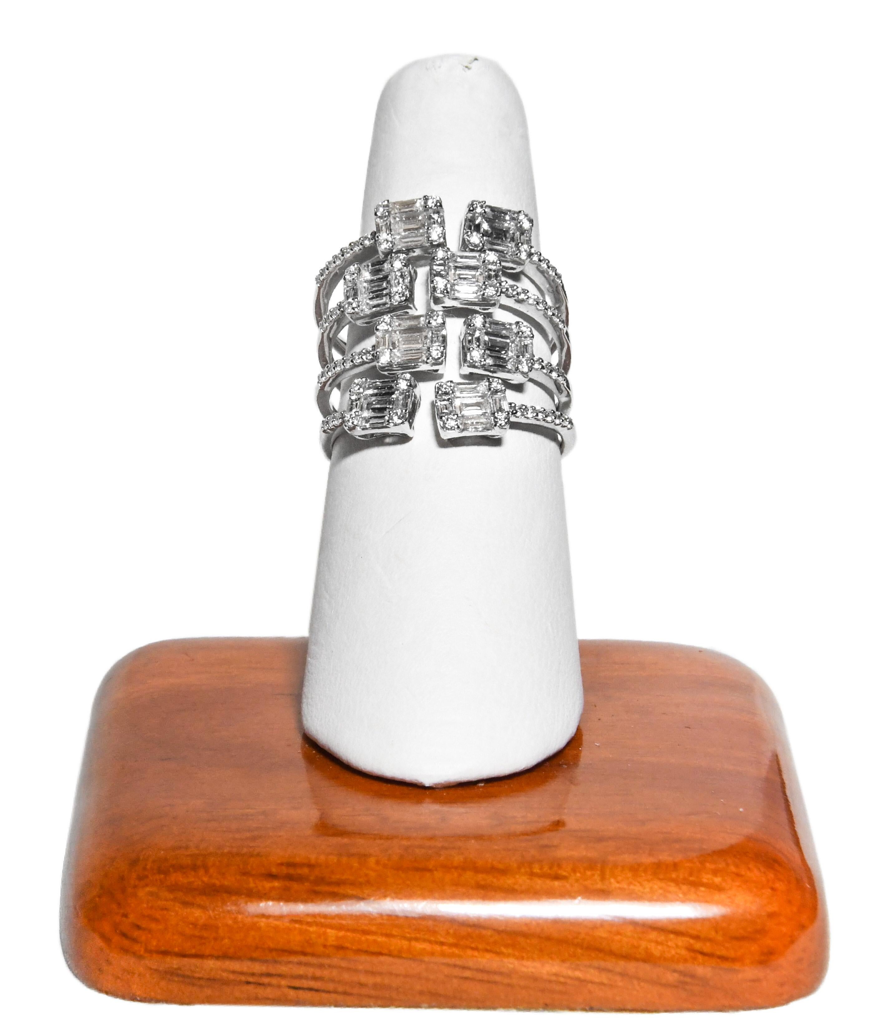 Meticulously crafted in 18 karat white gold this ring is truly award winning design.
First impressions are vital.  Upon first glance, this fabulous 4 row ring appears to have 8 quite large emerald cut diamonds.  Emerald shape sections are created