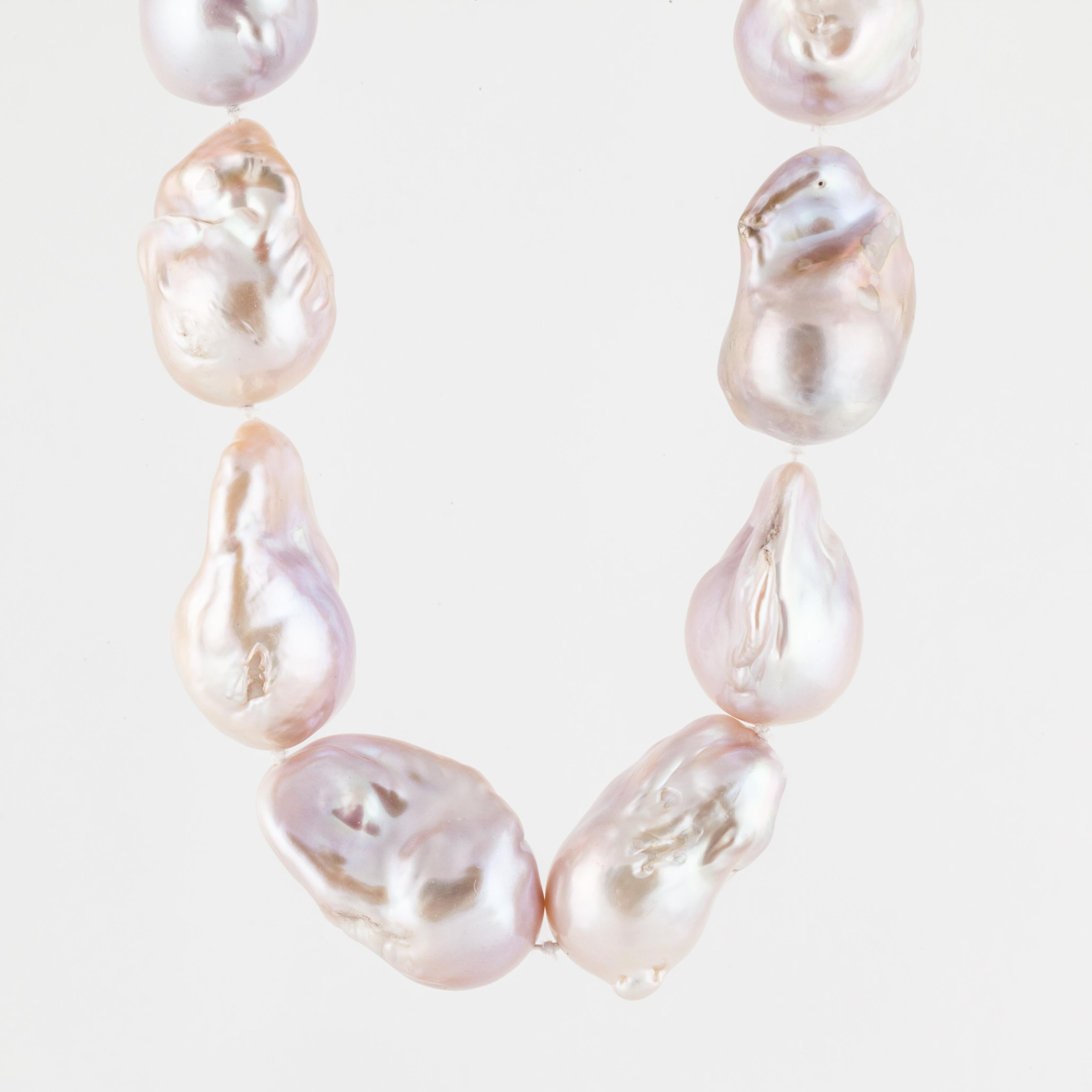 Cultured pink baroque freshwater pearl necklace with a brushed finished clasp in 18K yellow gold.  There are 17 pearls measuring 16-19mm.  Necklace is 18 inches long and 3/4 inches wide.