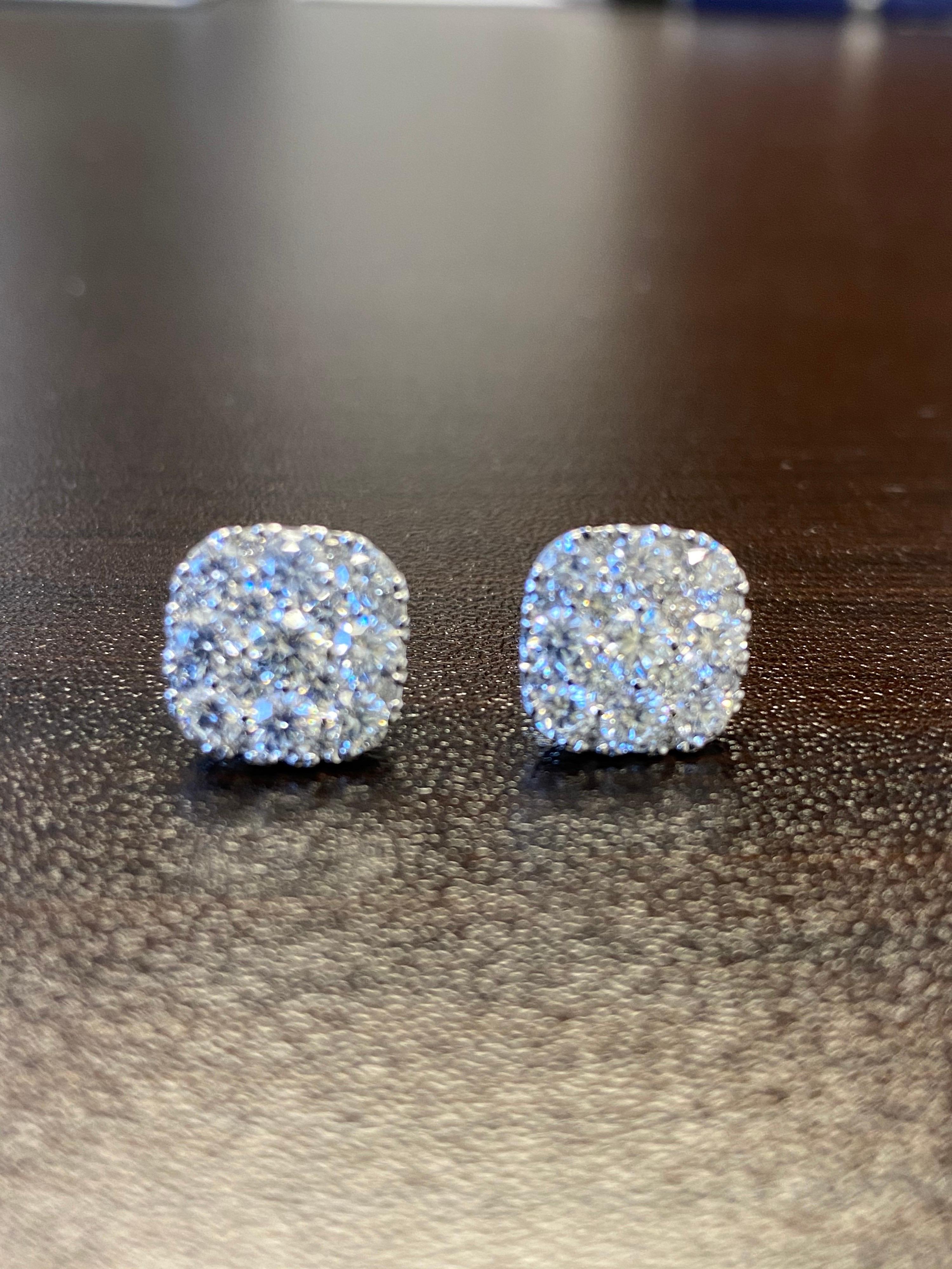 Diamond earrings set in 18K white gold. The earrings are a set with a cluster of round diamonds in a cushion style look. The total diamond weight is 2.82 carats. The color of the stones are F, the clarity is VS1.