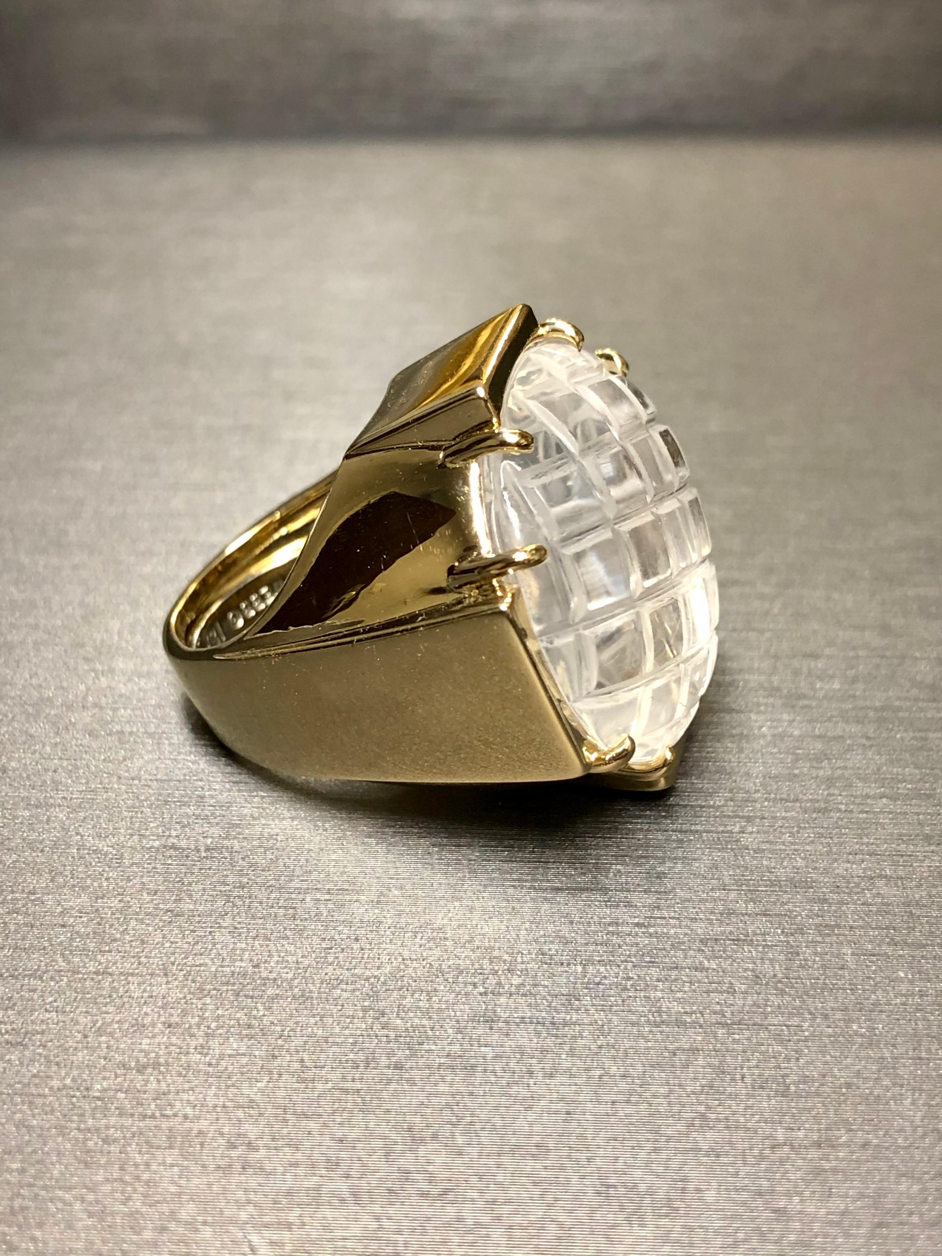 An original and one of a kind vintage ring done by David Webb. Crafted in 18K, this ring is centered by a beautifully carved dome of rock crystal quartz set a a stylishly designed heavy mounting. Freshly polished and ready to wear. One is available