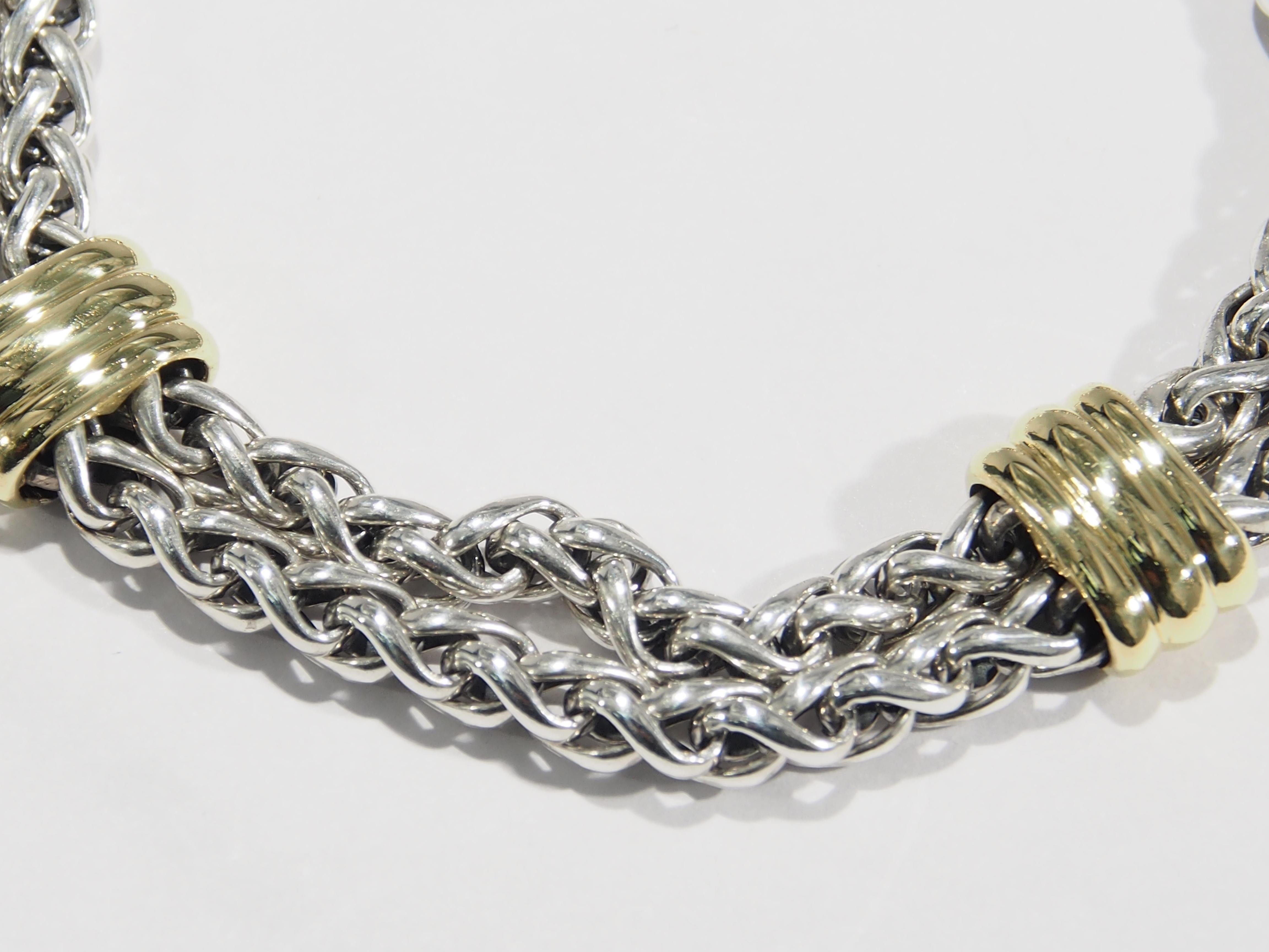 From one of America's favorite jewelry designer, David Yurman is this Wheat Link Bracelet. This compelling Bracelet is fashioned in a Double Strand Wheat Link accented with (2) 18K Yellow Gold Bars for an approximate width of 14mm. The Bracelet has