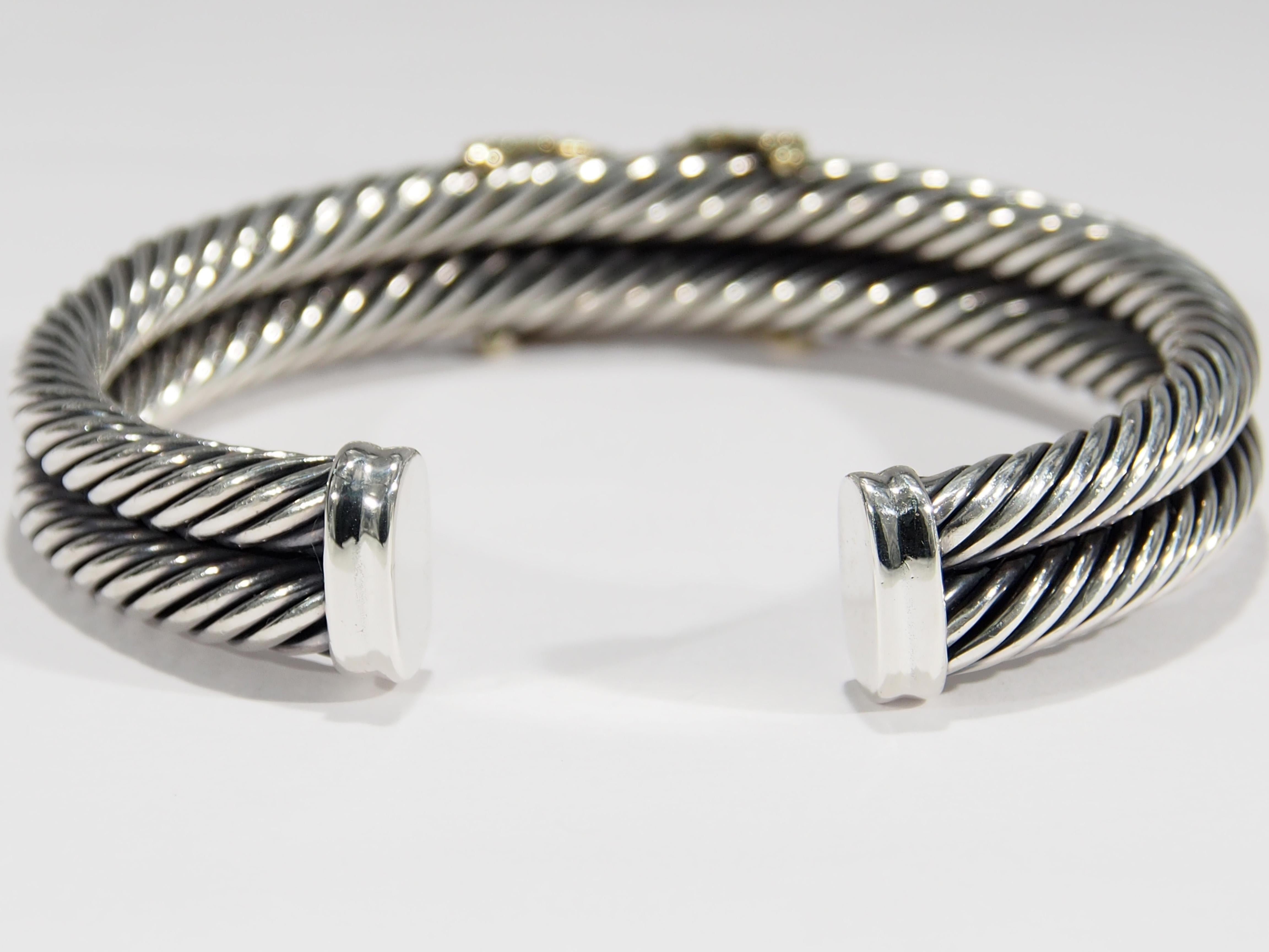 From a favorite designer David Yurman is this beautiful cuff bracelet from the Crossover X Collection featuring a double cable design in sterling silver. The center has a diamond set 