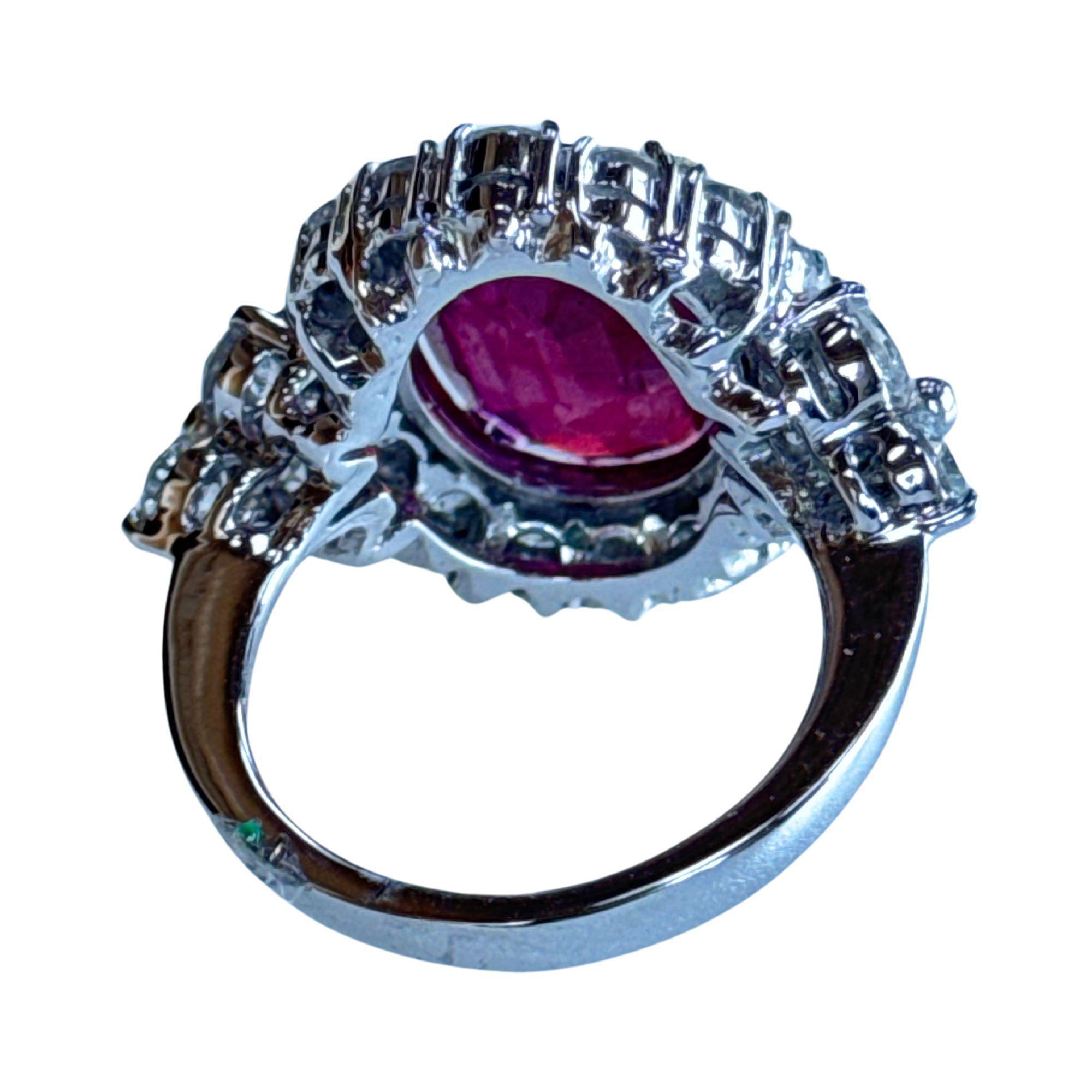 Feast your eyes on our 18k Diamond and African Ruby Ring. Crafted in 18k white gold, this ring has a striking 7.72 carat African Ruby center with dazzling 3.02 carat diamonds around it. This ring exudes elegance and sophistication. In good condition