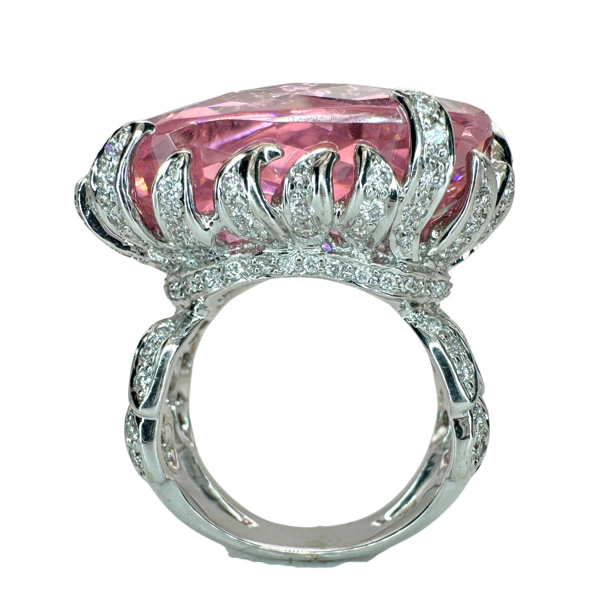 Indulge in luxury with our 18k Diamond and Pink Stone Center Cocktail Ring. The 50.47 carat pink stone takes center stage, surrounded by 1.10 carats of diamonds. Crafted from 18k white gold, this ring exudes sophistication and elegance. In good