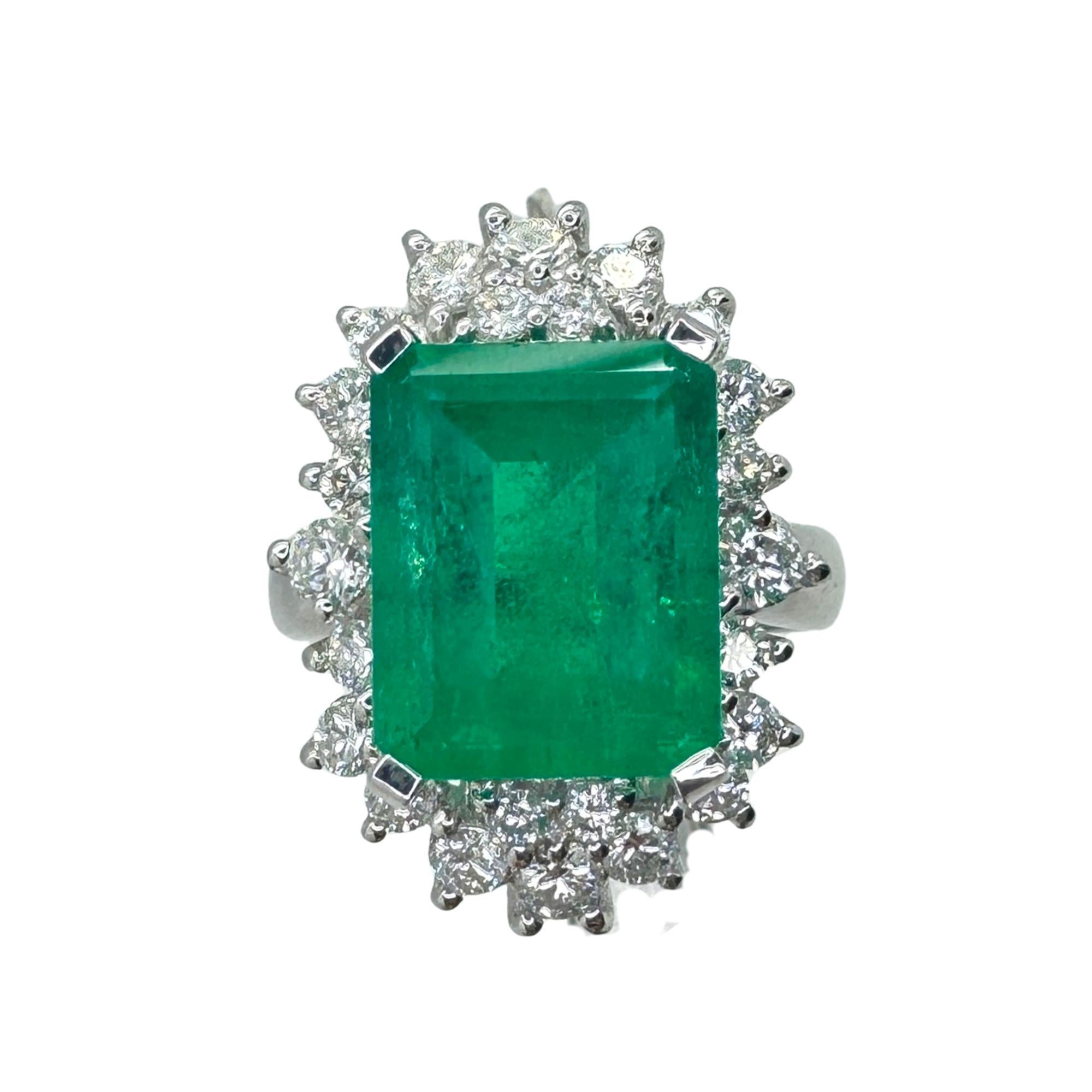 Indulge in pure luxury with our 18k Diamond and Emerald Ring. Crafted from gleaming 18k white gold and adorned with sparkling 1.04 carat diamonds and a breathtaking 5.18 carat emerald in the center, this ring exudes sophistication and elegance. With