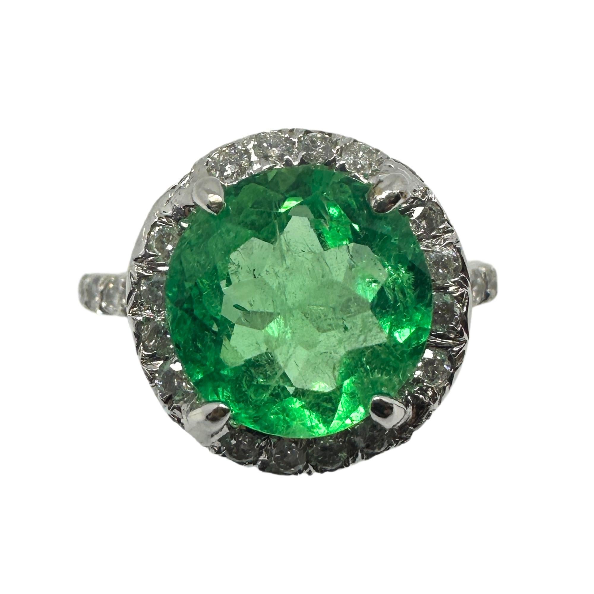 Add a touch of elegance to your jewelry collection with our 18k Diamond and Emerald Ring. Weighing 4.32 grams and with a size of 6.25, this stunning ring features a 2.96 carat round emerald at its center, surrounded by a sparkling diamond halo