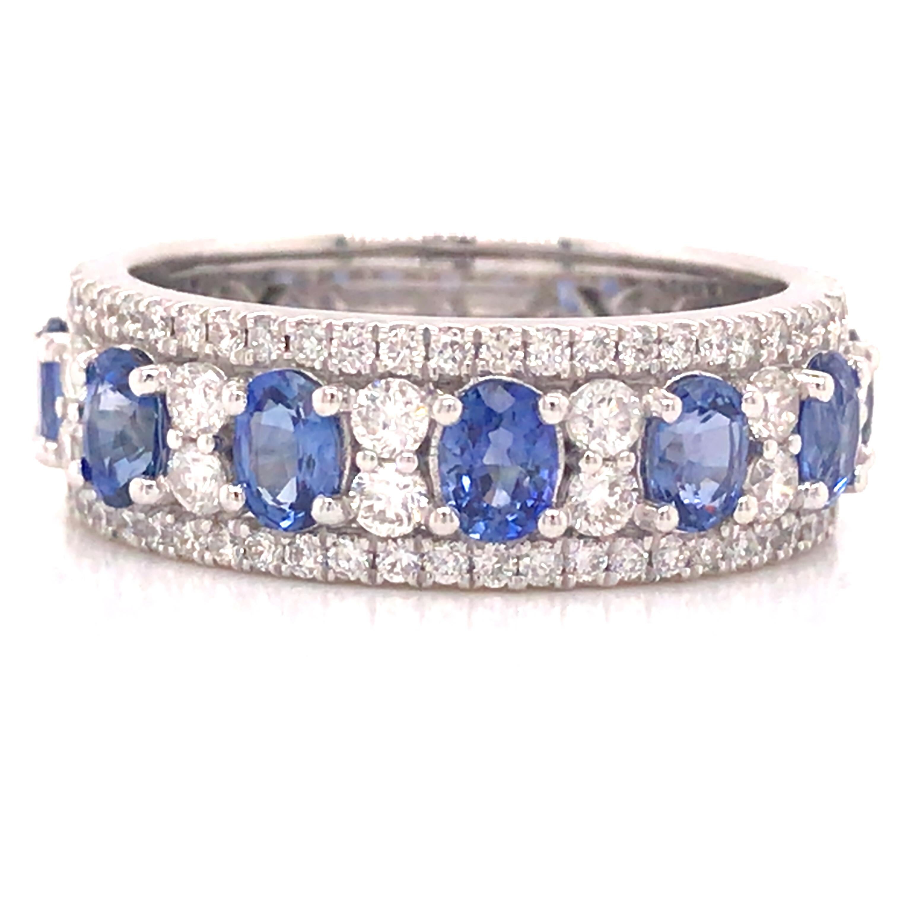 Diamond and Oval Sapphire Band in 18K White Gold.  Round Brilliant Cut Diamonds weighing 0.70 carat total weight, G-H in color and VS-SI in clarity and (7) Oval Blue Sapphires weighing 1.40 carat total weight are expertly set.  The Band measures 1/4