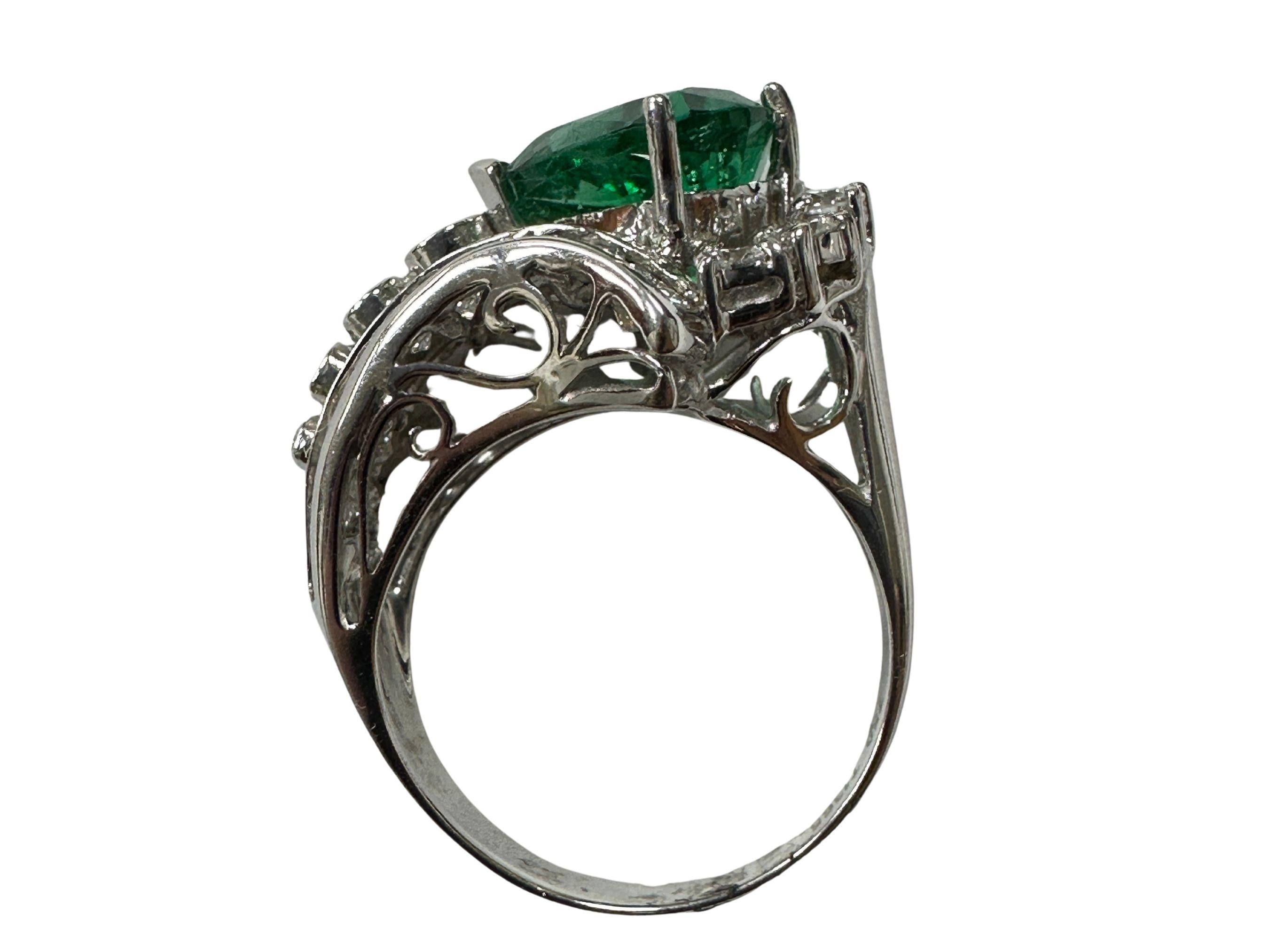 Indulge in the timeless allure of this 18k Diamond and Pear Shaped Emerald Ring, a stunning vintage piece in very good condition with minor surface wear consistent with its rich history.

Crafted in 18k white gold, weighing 7.33 grams, this ring
