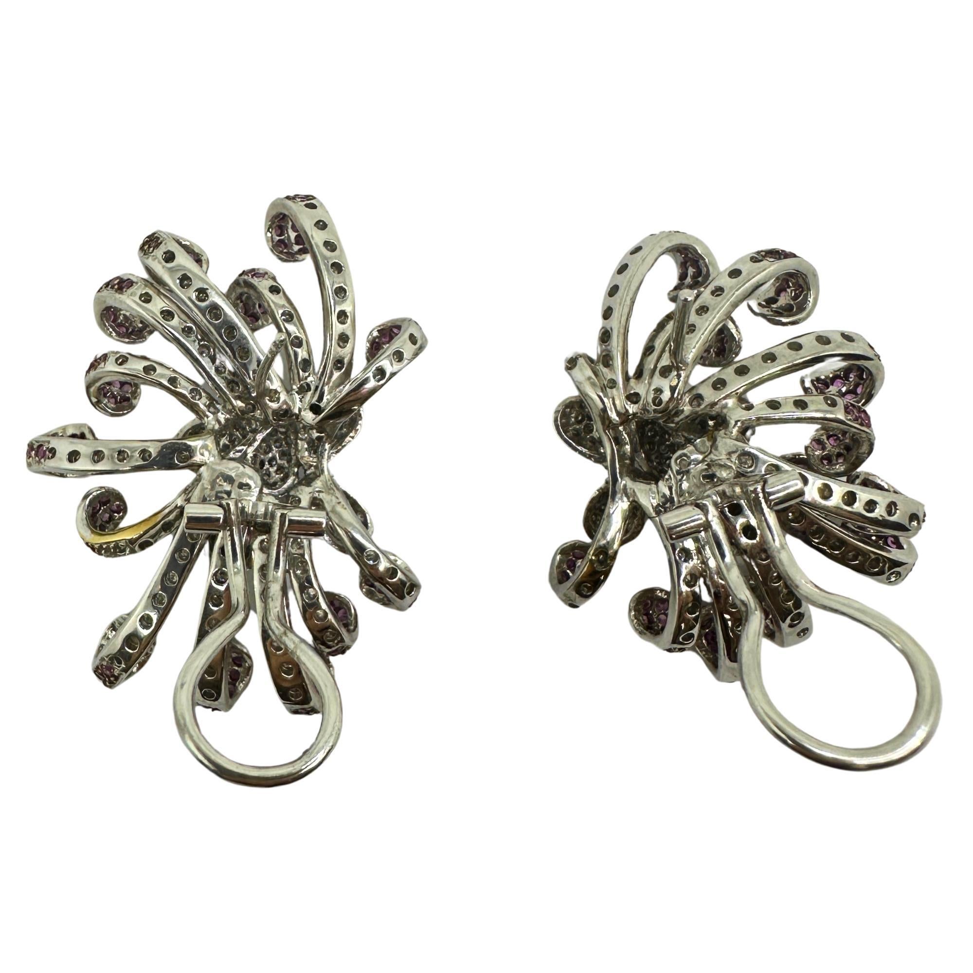 Elevate your style with these stunning 18k white gold earrings adorned with 3.12 carats of sparkling diamonds and 2.24 carats of pink sapphire. In good condition with a weight of 28.9 grams, these 1.50 inch statement earrings are the perfect