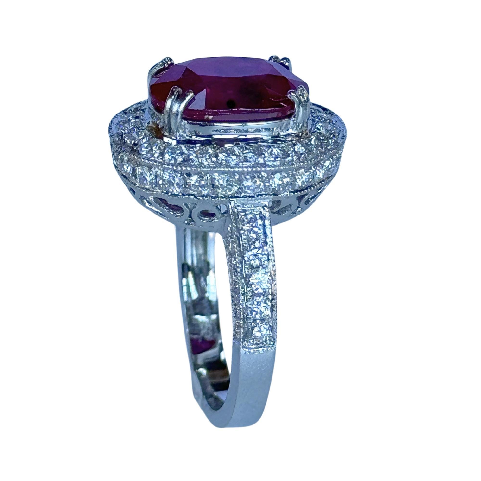Indulge in the ultimate luxury with our 18k Diamond and Ruby Ring. Crafted with 18k white gold and adorned with 1.03 carats of sparkling diamonds around a 3.48 carat ruby, this ring is a true work of art. With a weight of 7.28 grams and a size of