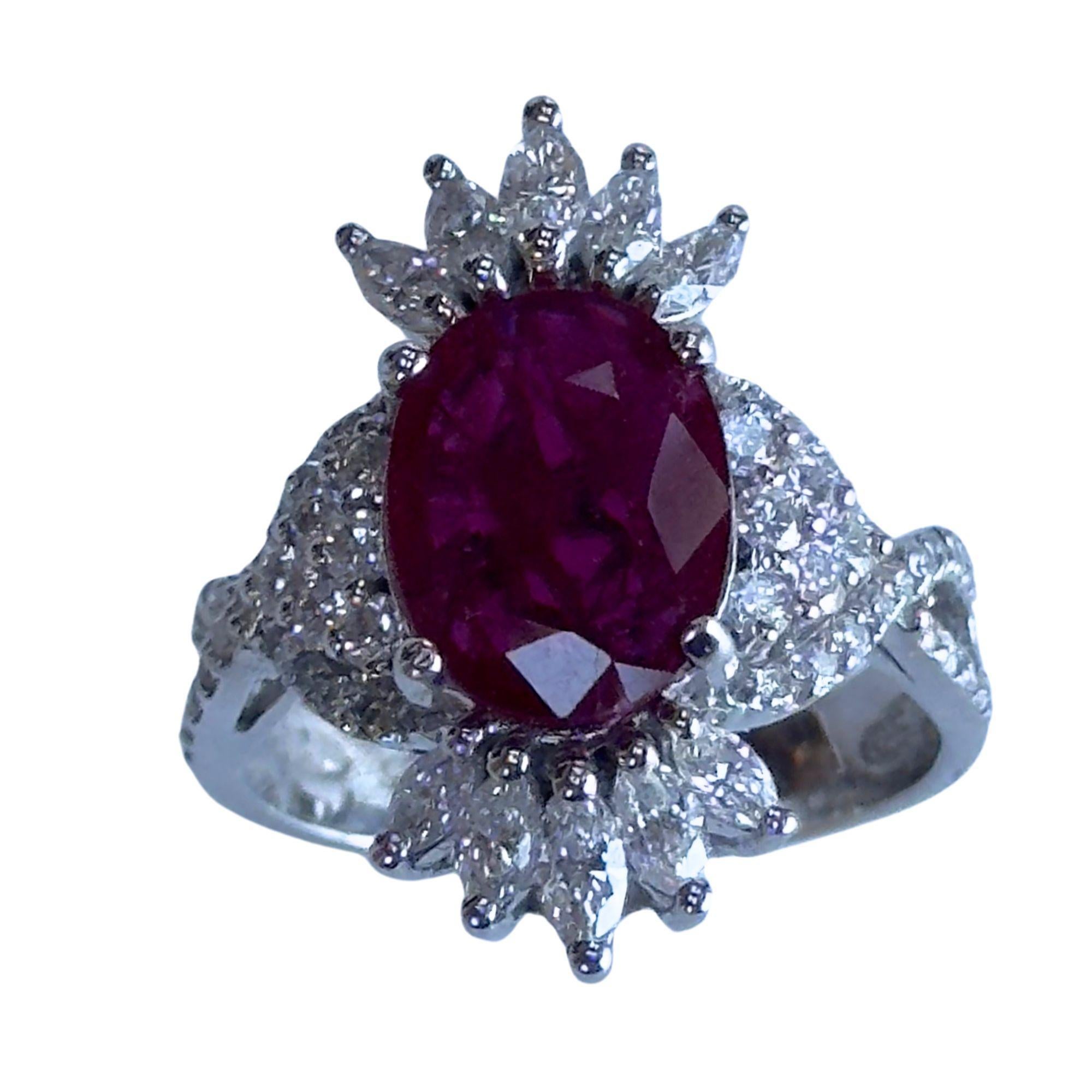 Crafted in elegant 18k white gold, this stunning ring features sparkling 1.26 carat diamonds and a vibrant 2.49 carat ruby center. The ring is marked with 