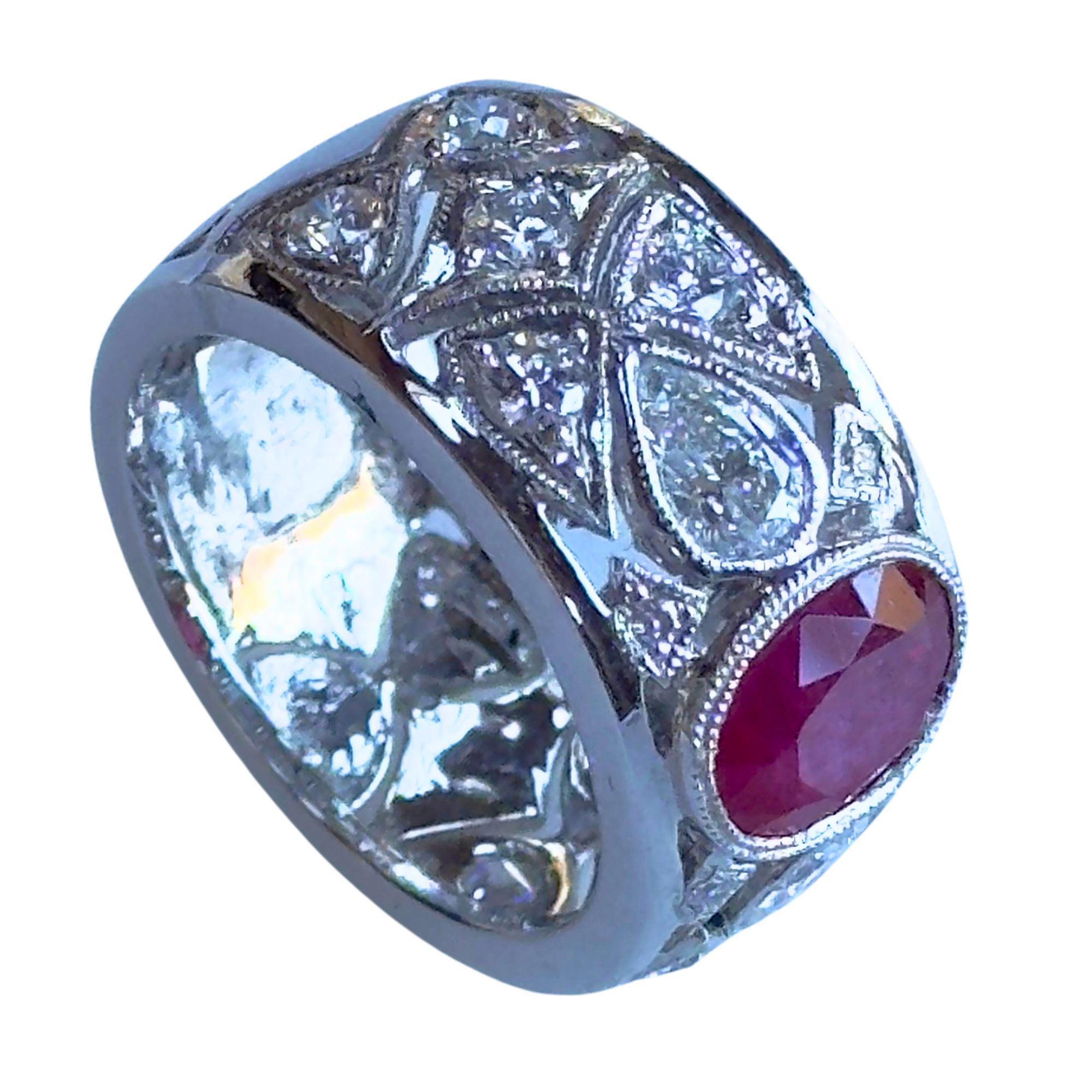Add a touch of elegance to your jewelry collection with this 18k Diamond and Ruby Wide Band Ring. Crafted in 18k white gold, it features 1.18 carats of sparkling diamonds and 2.04 carat ruby center. In good condition with minor surface wear, it's a