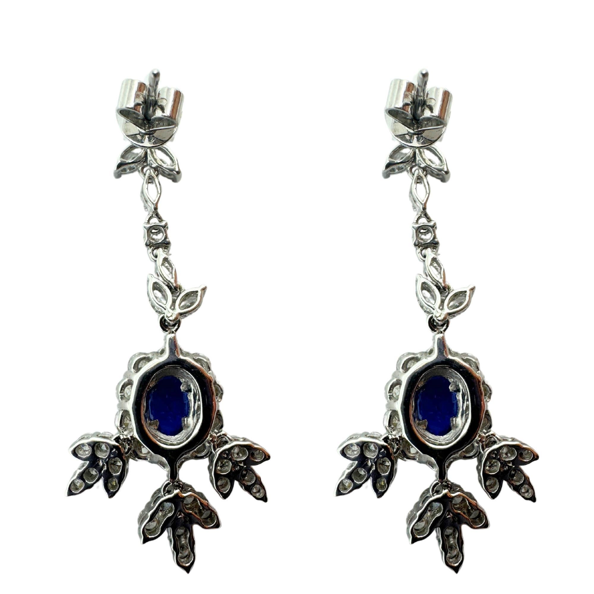 Add a touch of sophistication to any outfit with these 18k diamond and sapphire earrings. Hand-crafted in 18k white gold, each earring features 2.66 carats of sparkling diamonds and 0.92 carats of deep blue sapphires. Measuring 1.5 inches in length,