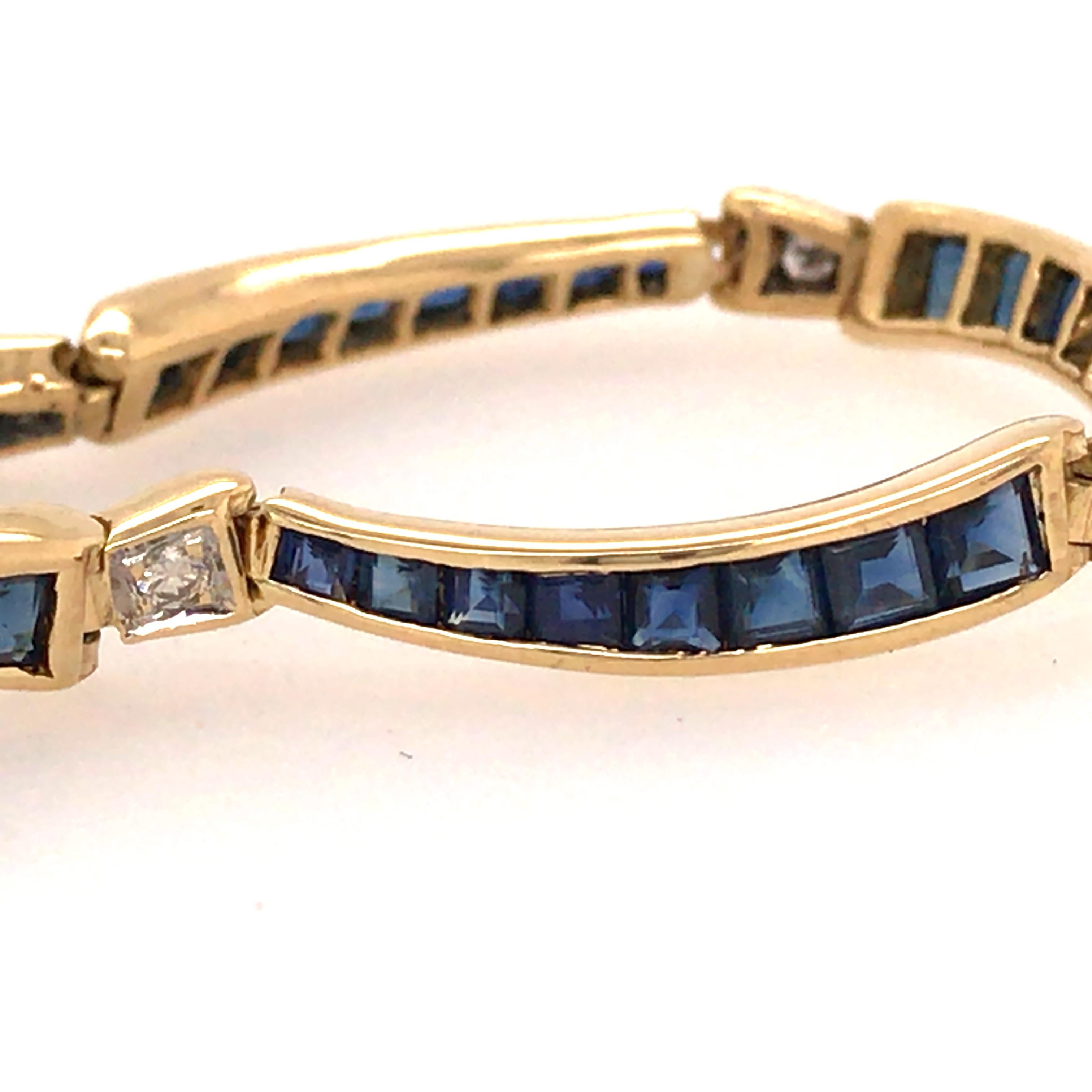 Diamond and Sapphire Link Bracelet in 18K Yellow Gold.  Links channel set with Sapphire Gemstones are alternating with (8) Round Brilliant Cut Diamonds weighing .09 carat total weight G-H in color and VS-SI in clarity.  The bracelet measures 7