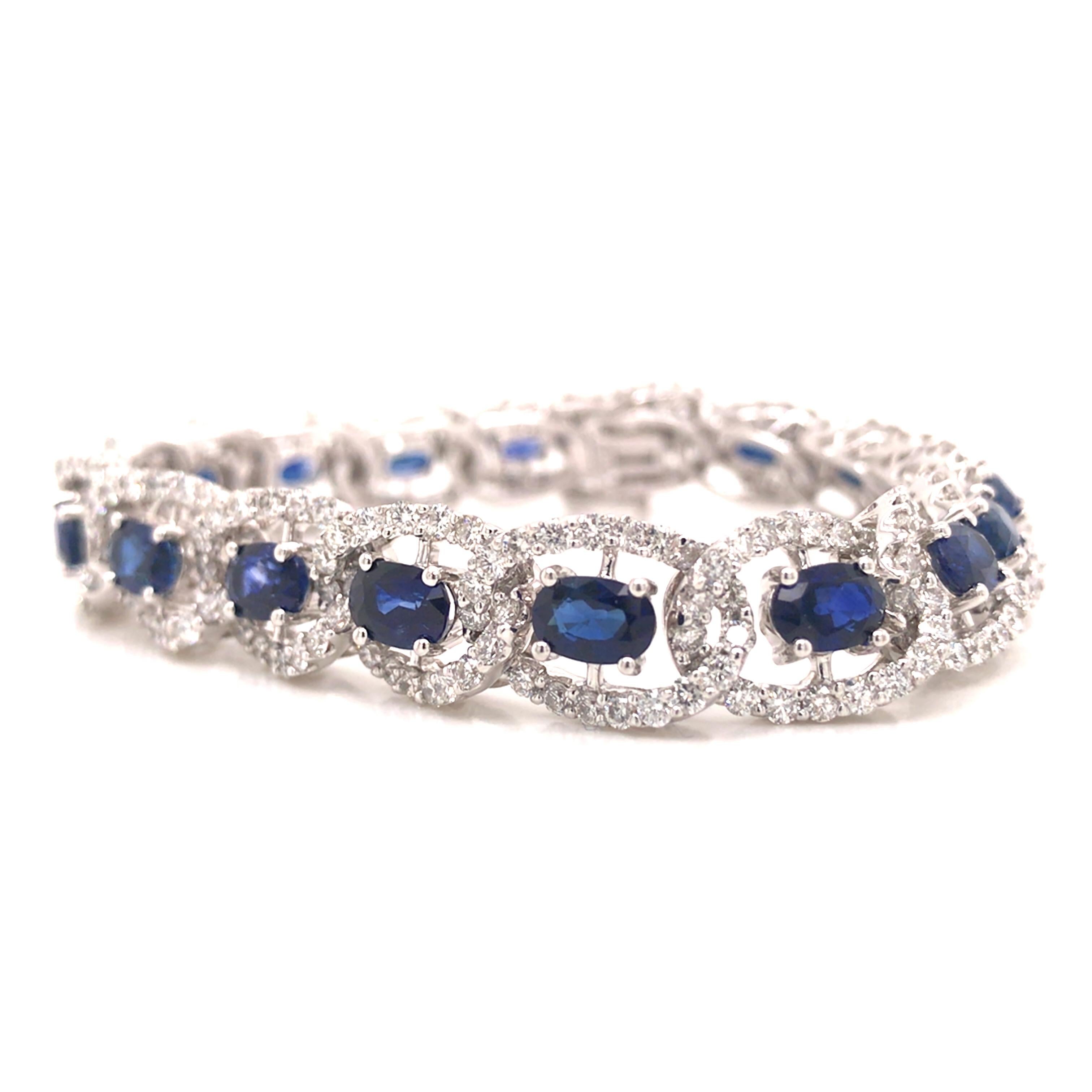 Diamond and Sapphire Link Tennis Bracelet in 18K White Gold.  Round Brilliant Cut Diamonds weighing 6.50 carat total weight, G-H in color and VS in clarity and Blue Oval Sapphires weighing 12 carat total weight are expertly set.  The Bracelet