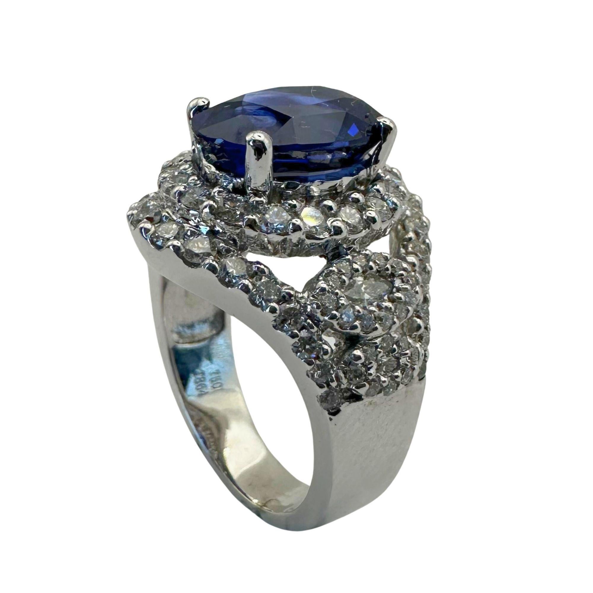 Indulge in luxury with our 18k Diamond and Sapphire Ring. Crafted from 18k white gold, this exquisite piece features a stunning 4.43 carat sapphire at its center, encircled by 1.34 carats of glittering diamonds. With a weight of 12.33 grams and a