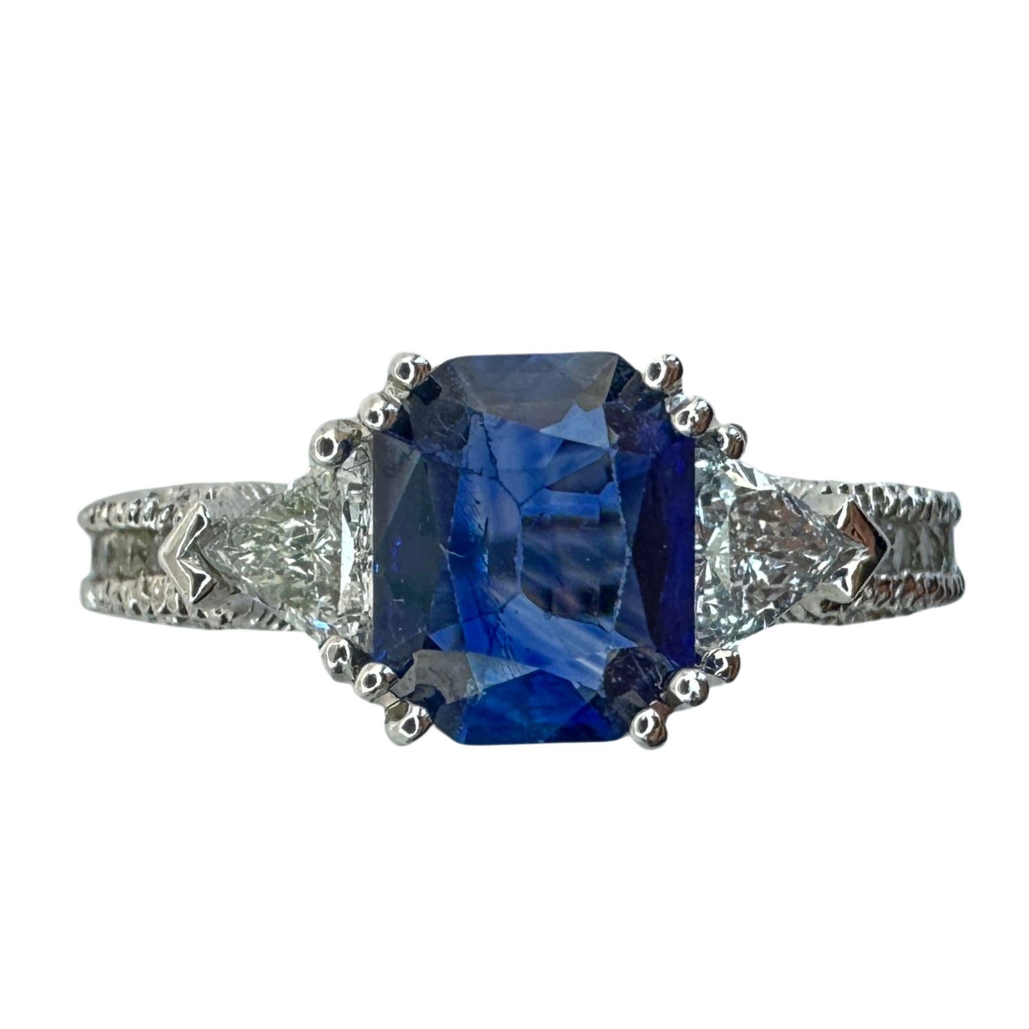 Experience elegance and luxury with our 18k Diamond and Sapphire Ring. Featuring a brilliant 1.28 carat sapphire at its center, surrounded by sparkling 0.35 carat trillion cut and 0.53 carat round cut diamonds, this ring is truly a statement piece.