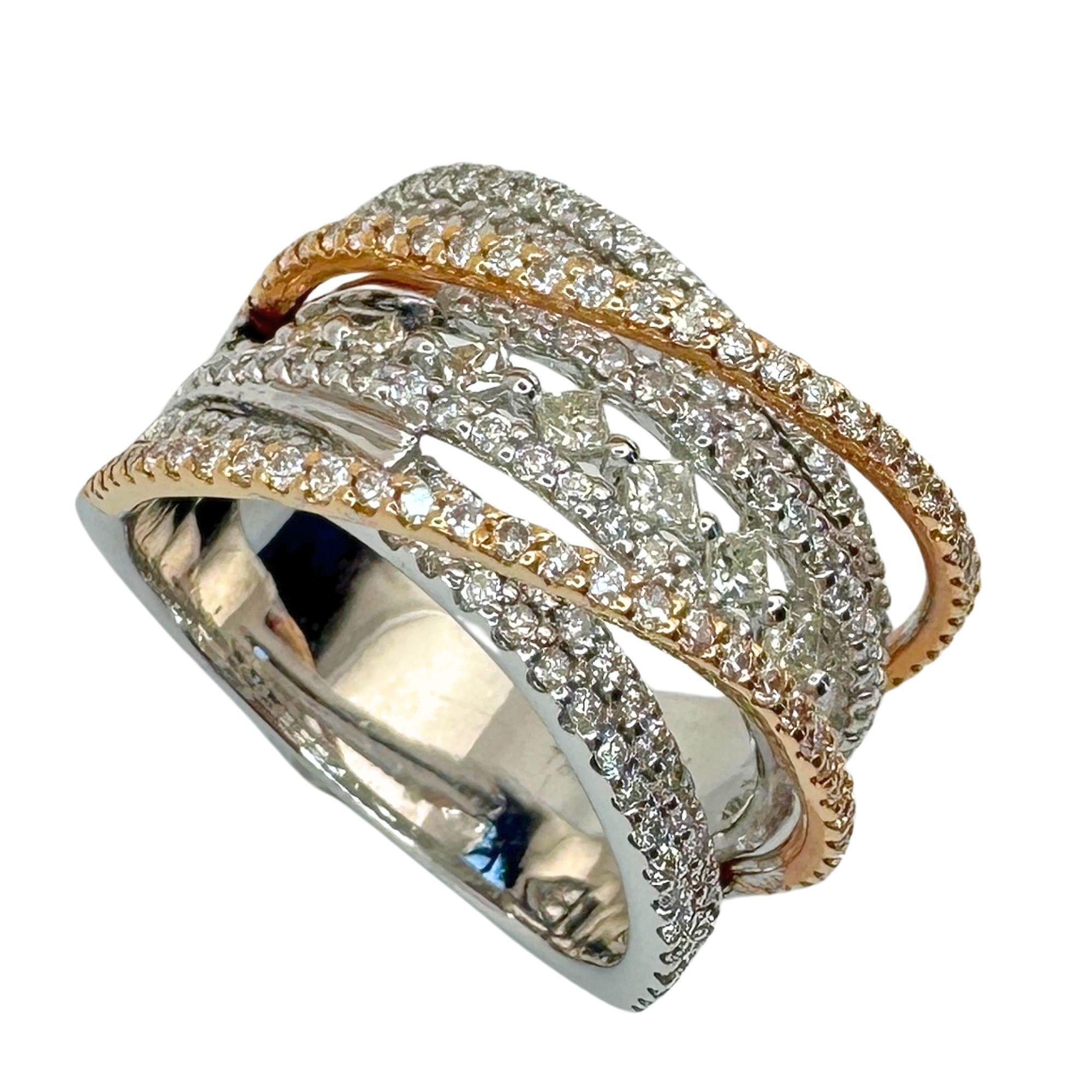 This elegant 18k diamond band ring, with a ring size of 7, boasts a total weight of 1.27 carats. The stunning row of princess cut diamonds in the middle, weighs 0.32 carats in total, is complemented by 0.95 carats of round cut diamonds all around.