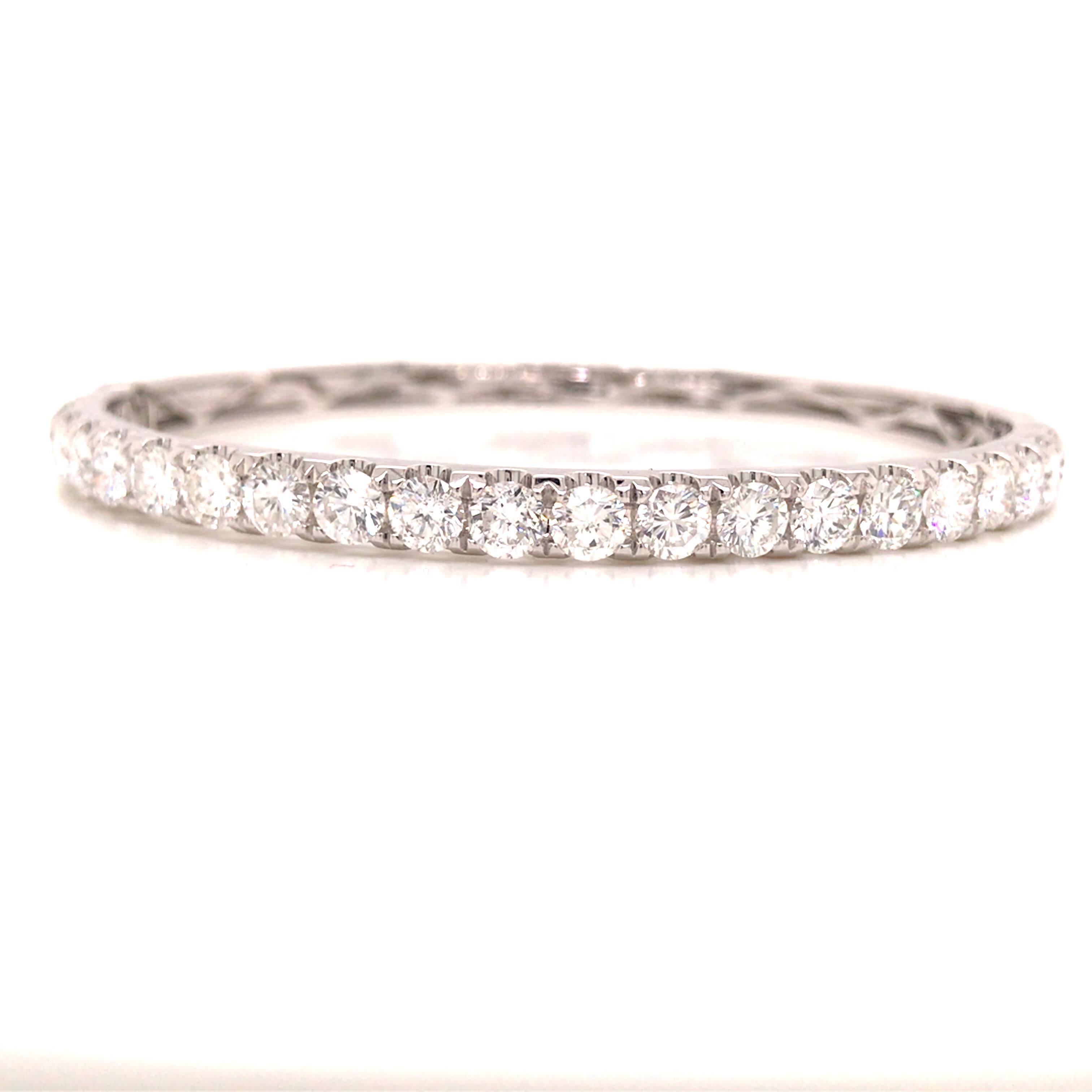 Diamond Bangle Bracelet in 18K White Gold. (21) Round Brilliant Cut Diamonds weighing 5.0 carat total weight, G-H in color and VS-SI in clarity. The Bangle measures 6.25 inch inner circumference and 3/16 inch in width. 17.10 grams.