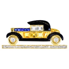 18K, Diamond, Blue and Yellow Sapphire and enamel Vintage Car Brooch.