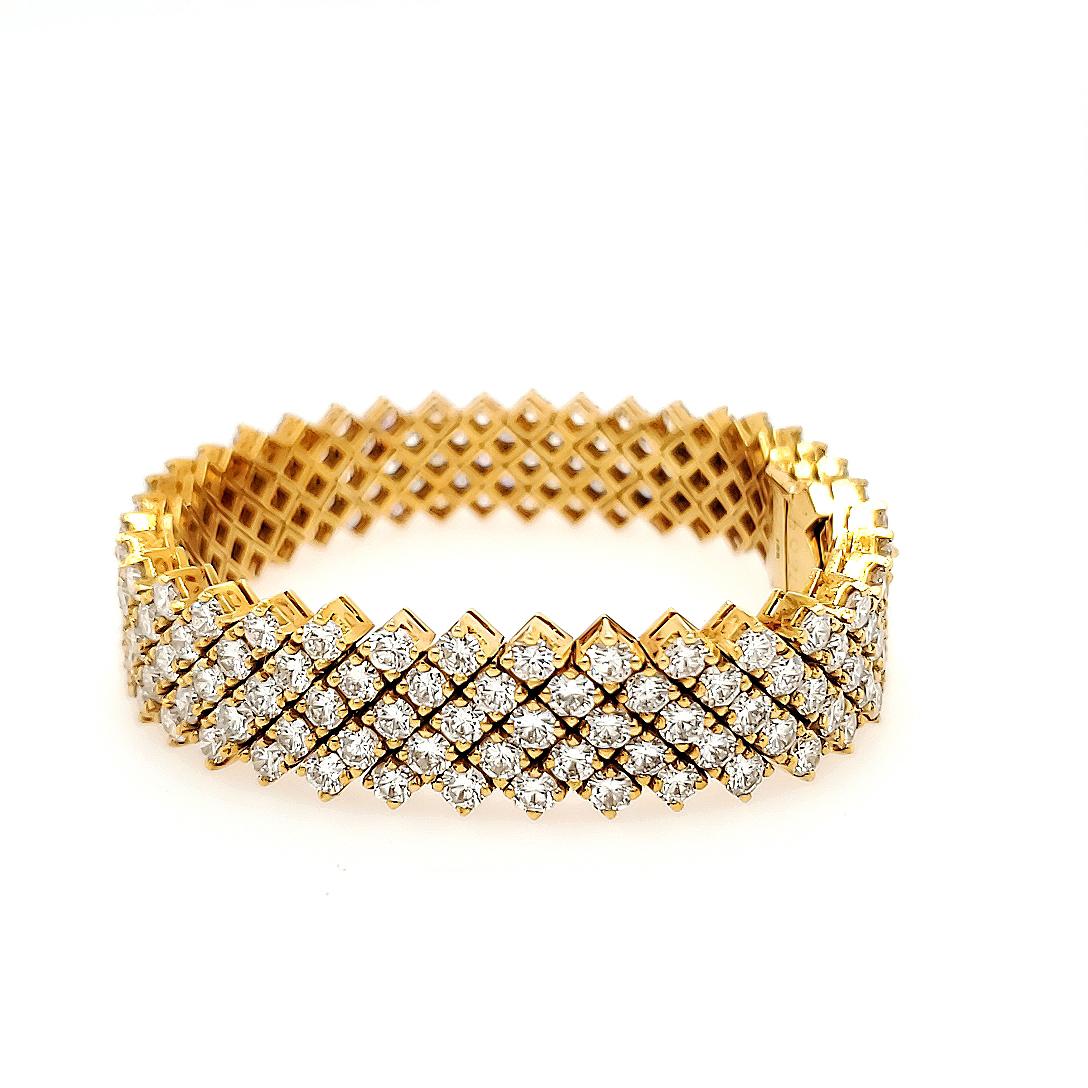 Four Row Diamond Flexible Weave Bracelet in 18K Yellow Gold. Prong set with 190 Round Brilliant Cut Diamonds 22.88 carat total weight G-H in color and VS in clarity. 7 inches in length, 1/2 inch wide and 55.9 grams.
