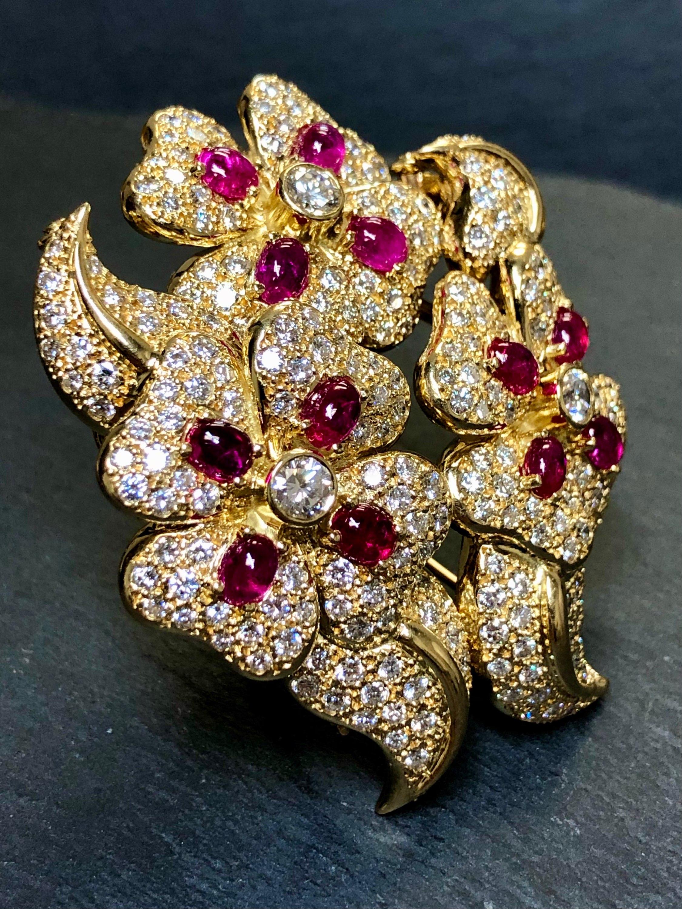 This fabulous brooch has been done in 18K yellow gold and set with approximately 8.50cttw in H-I color and Vs1-2 clarity round diamonds as well as approximately 6cttw in natural cabochon rubies. The unique aspect to this piece is it comes apart and