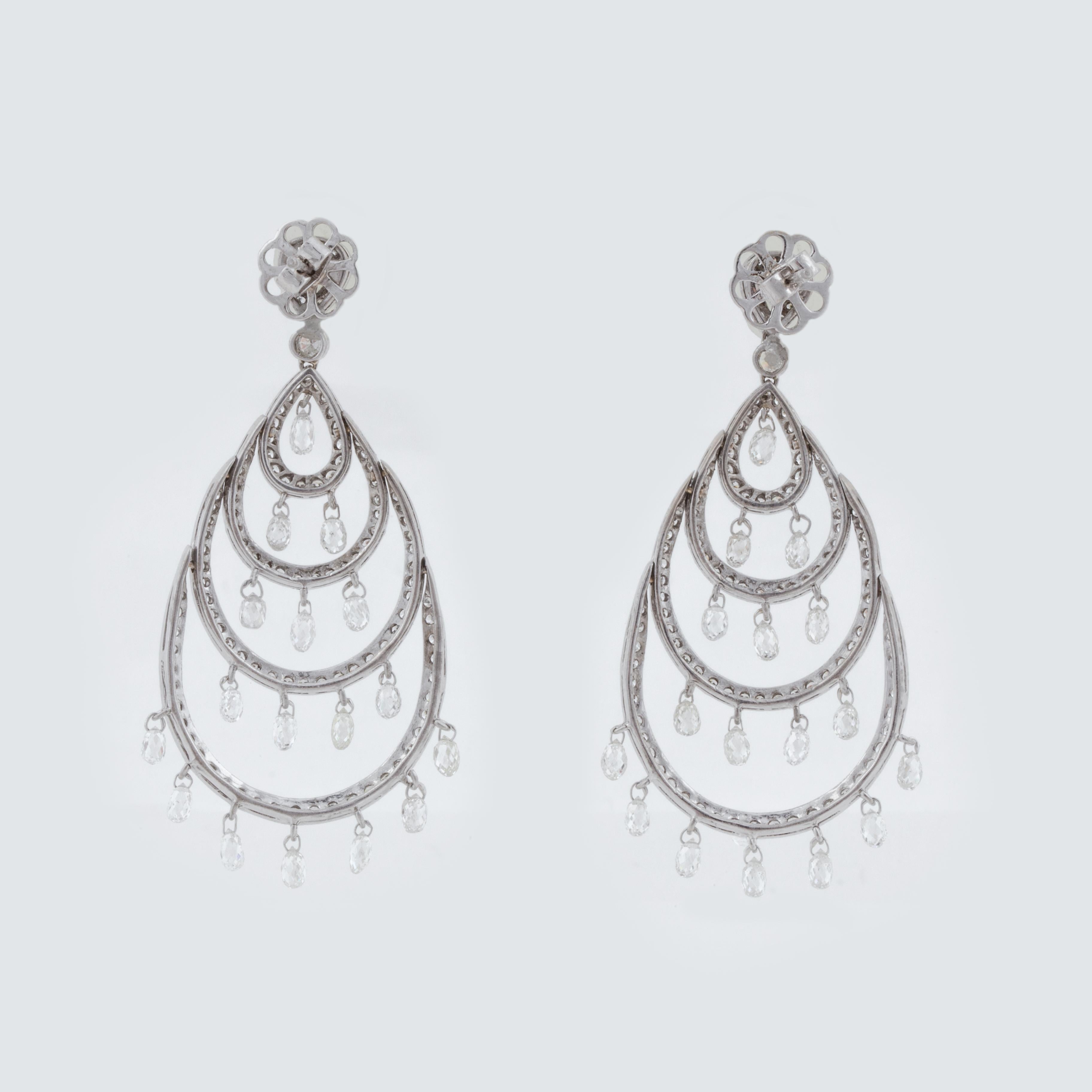 18K white gold chandelier earrings with round, rose-cut, and briolette diamonds. There are 24 briolette diamonds, 2 rose-cut diamonds and 236 round diamonds that total 11 carats; G-I color and VS2-SI2 clarity.  They are for pierced ears with a post