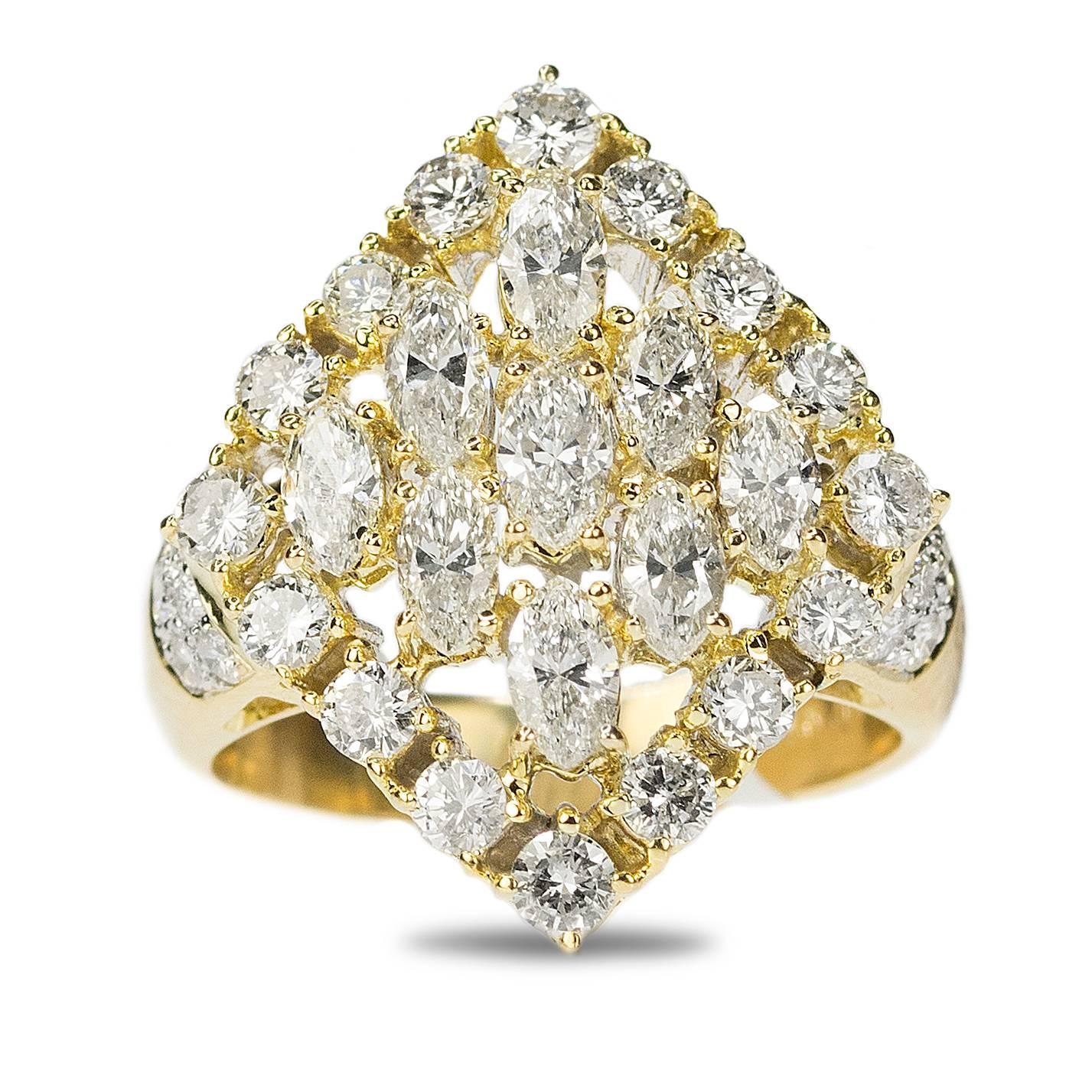 Substantial 18k yellow gold ring with approximately 3.00 carats of collection color/clarity Marquis and Round Brilliant diamonds.