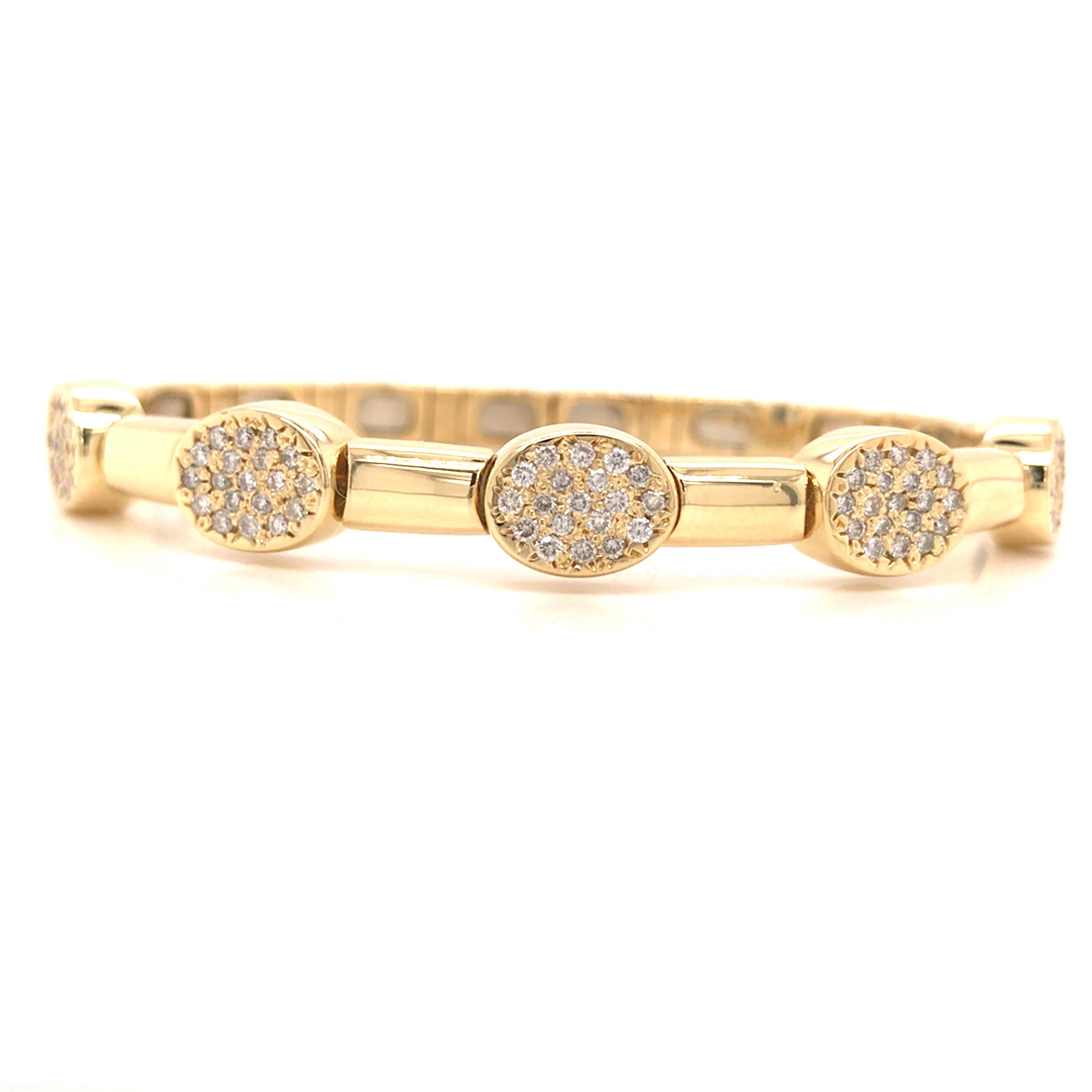 Diamond Cluster Station Bangle in 18K Yellow Gold.  Round Brilliant Cut Diamonds weighing 1.10 carat total weight, G-H in color and VS in clarity are expertly set in (5) Oval stations.  The Bangle measures 6 1/4 inch inner circumference and 5/16