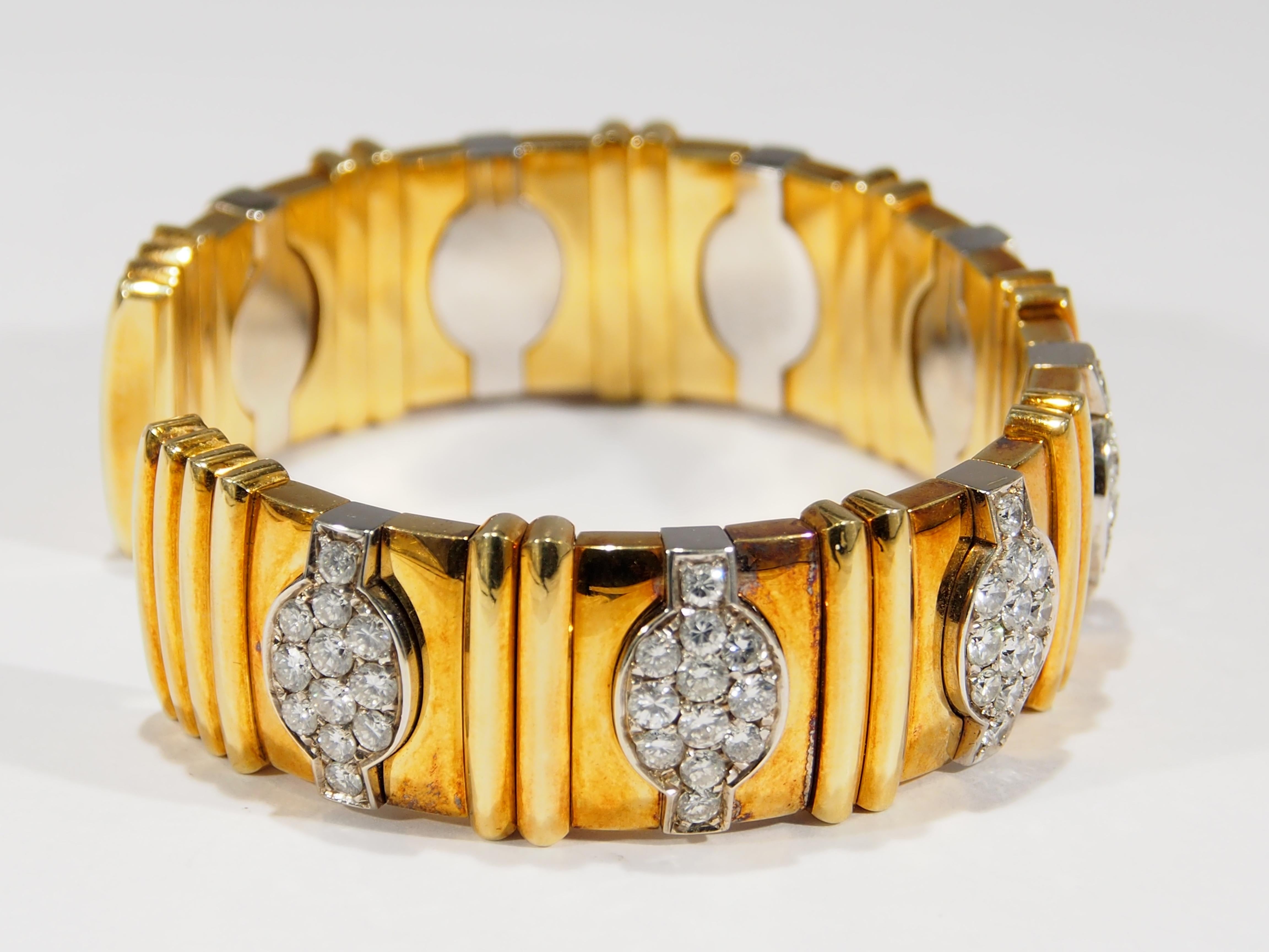 This is a stunning 18K Two Tone Gold Wide Cuff Bracelet created with Hand-Made details. The Bracelet has (96) Round Brilliant Cut Diamonds set in 8 sections. The Diamonds are G-H in color, VS in clarity and approximately 6.40 total weight. The