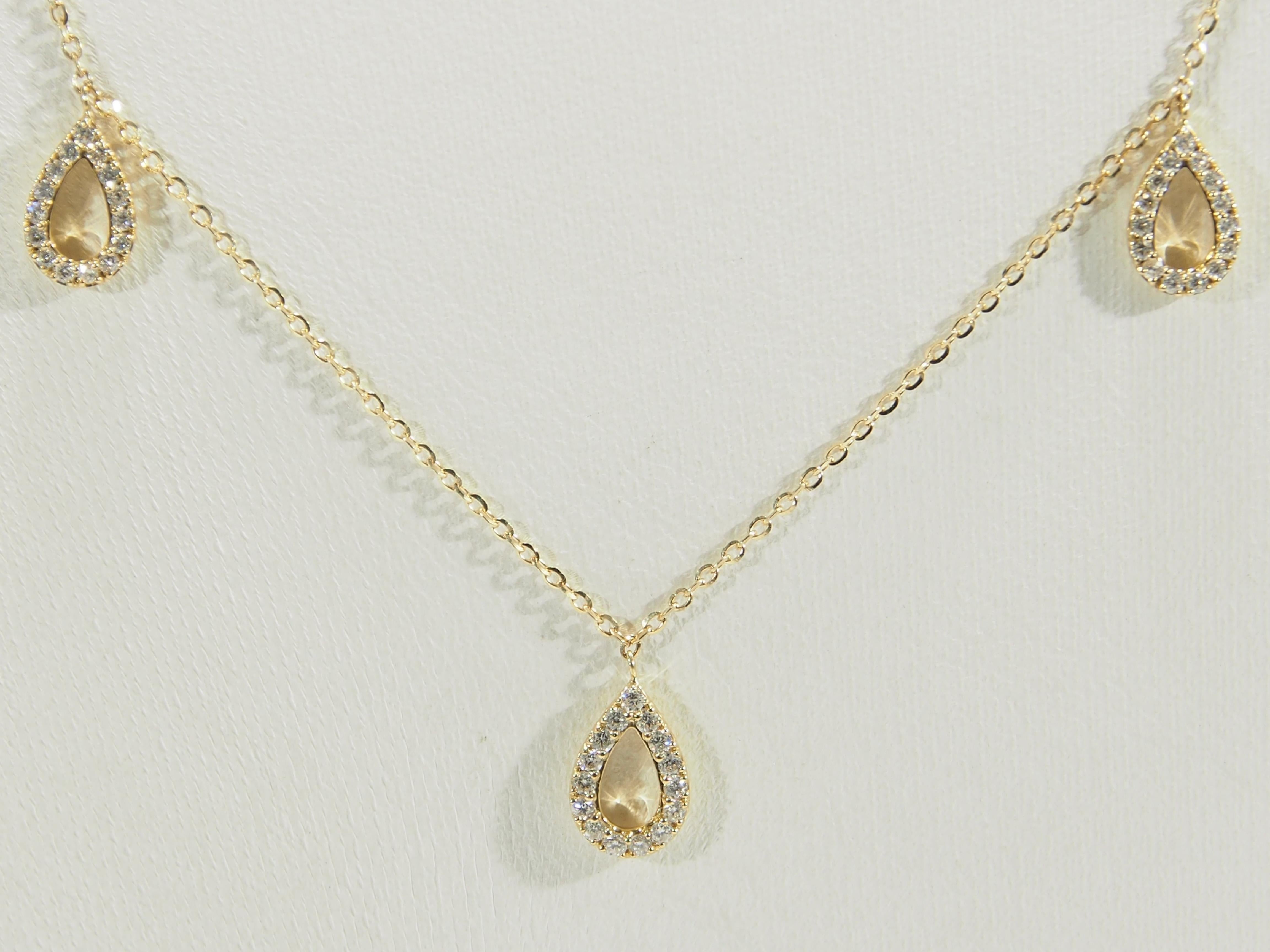 A delicate 18K Yellow Gold Necklace with (75) Round Brilliant Cut Diamonds set in (5) pear shaped stations on a 18