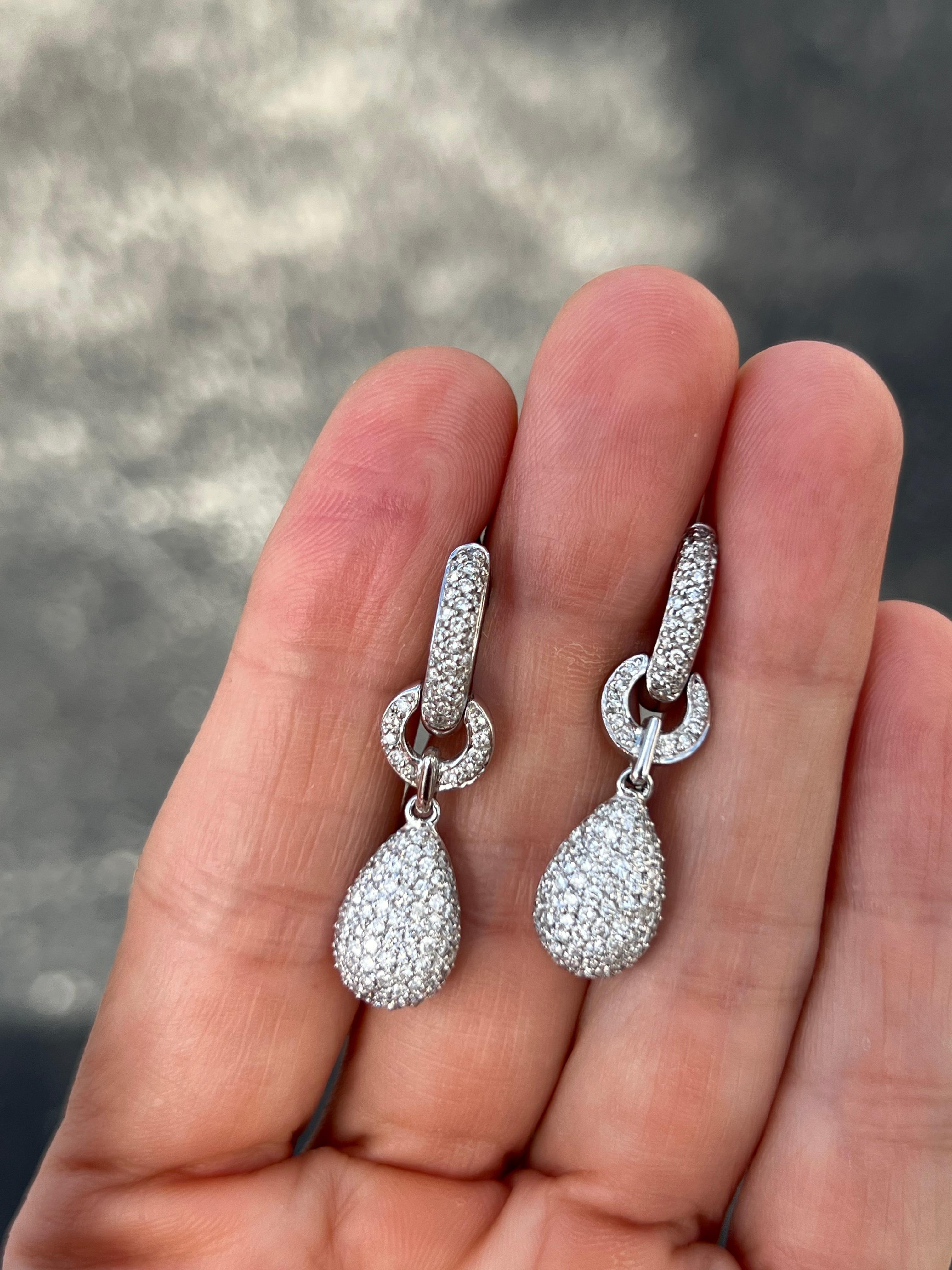 18K white gold huggy style earrings with diamond drop. 

Features
18K white gold
1.74 carat total weight in diamonds
The width of the huggy hoop is 3mm
The diamond drop measures approx. 15x9mm
The entire earring length is 36mm or 1.4 inches.