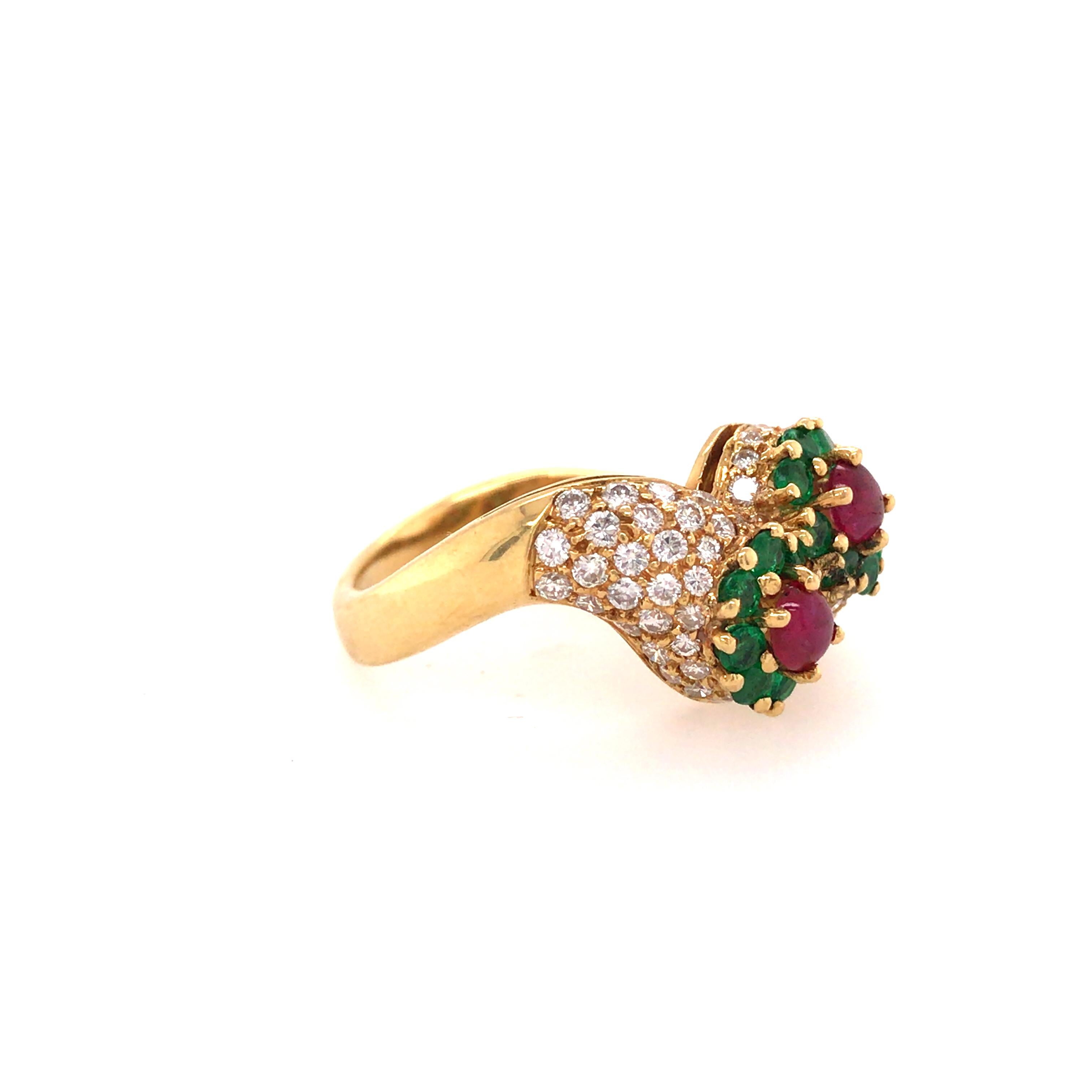 Diamond, Emerald and Ruby Ring in 18K Yellow Gold.  (68) Round Brilliant Cut Diamonds weighing 1.05 carat total weight, G-H in color and VS in clarity, (16) Emeralds weighing 1.03 carat total weight and (2) Ruby Gemstones weighing .65 carat total